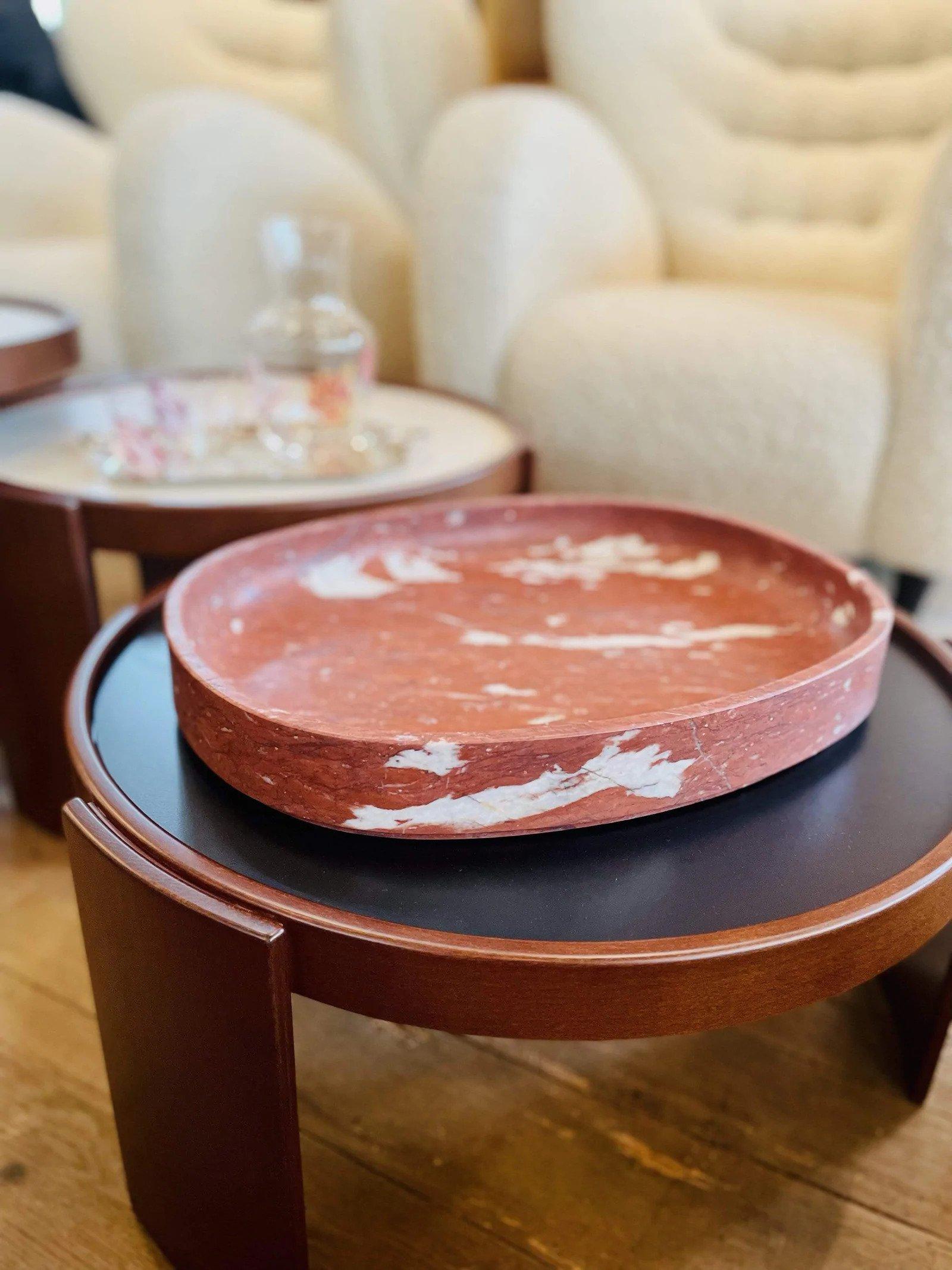 These versatile tables are made of beechwood with a walnut stain and have interchangeable black and white laminate tops. Each one has a 24 inch diameter and varies in height. They can be stacked to form a sculptural effect or placed individually