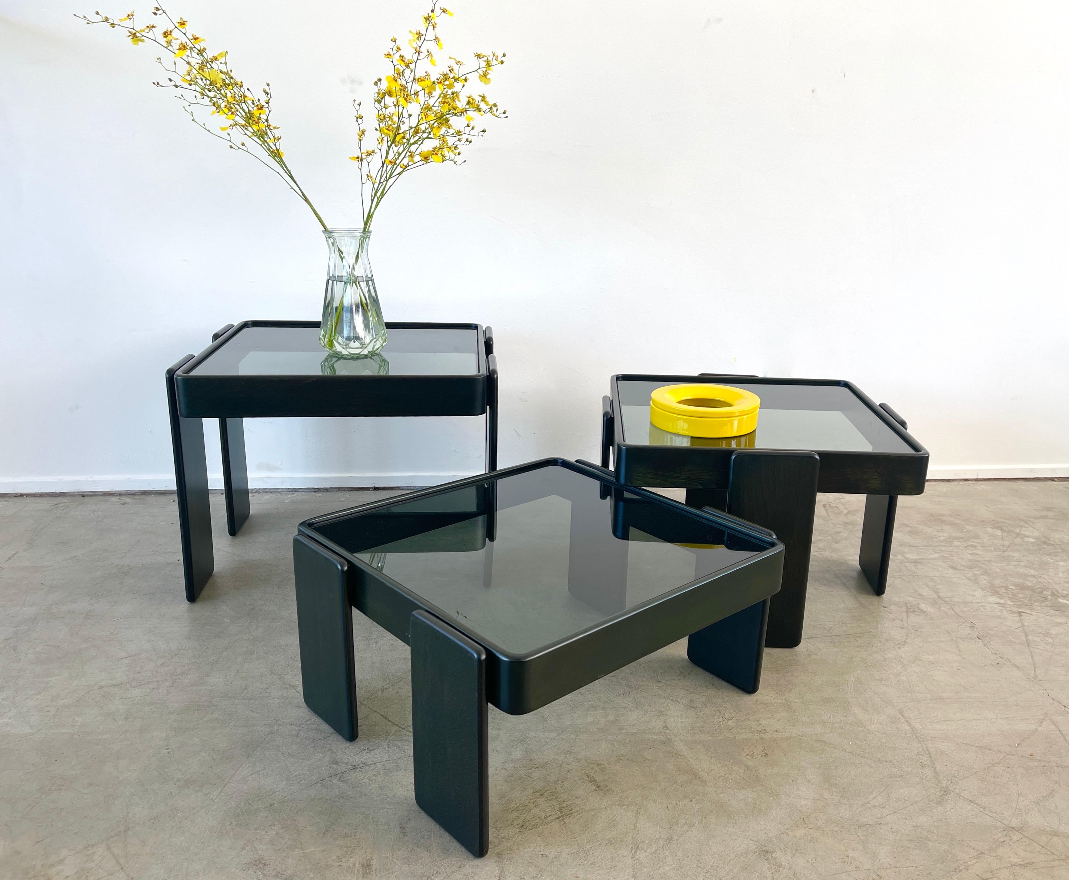 Set of three stacking tables by Gianfranco Frattini, Italy, 1970s. 
Newly refinished stained in subltle dark green with original black glass. 
Tables stack and nest in different heights. 
Measures: 19.5cm - 37.5cm - 45.5cm.
 