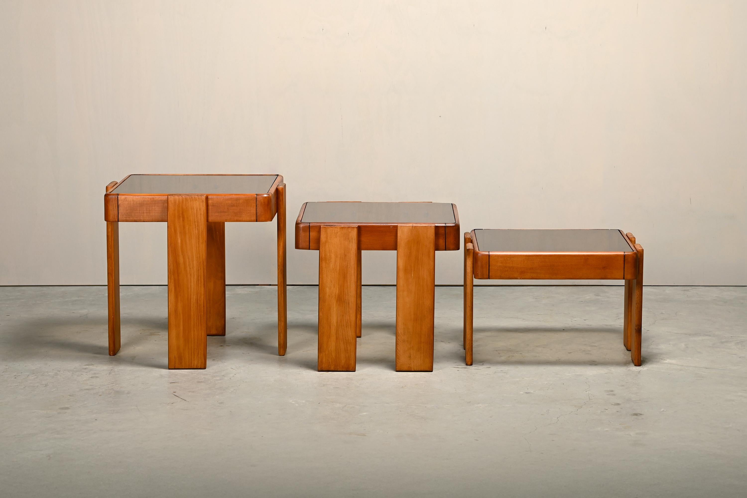Nesting Tables designed by Gianfranco Frattini. Early edition manufactured by Meblo for Cassina, 1970s. Solid wood frames with smoked glass table tops. Good condition with minor traces of use.