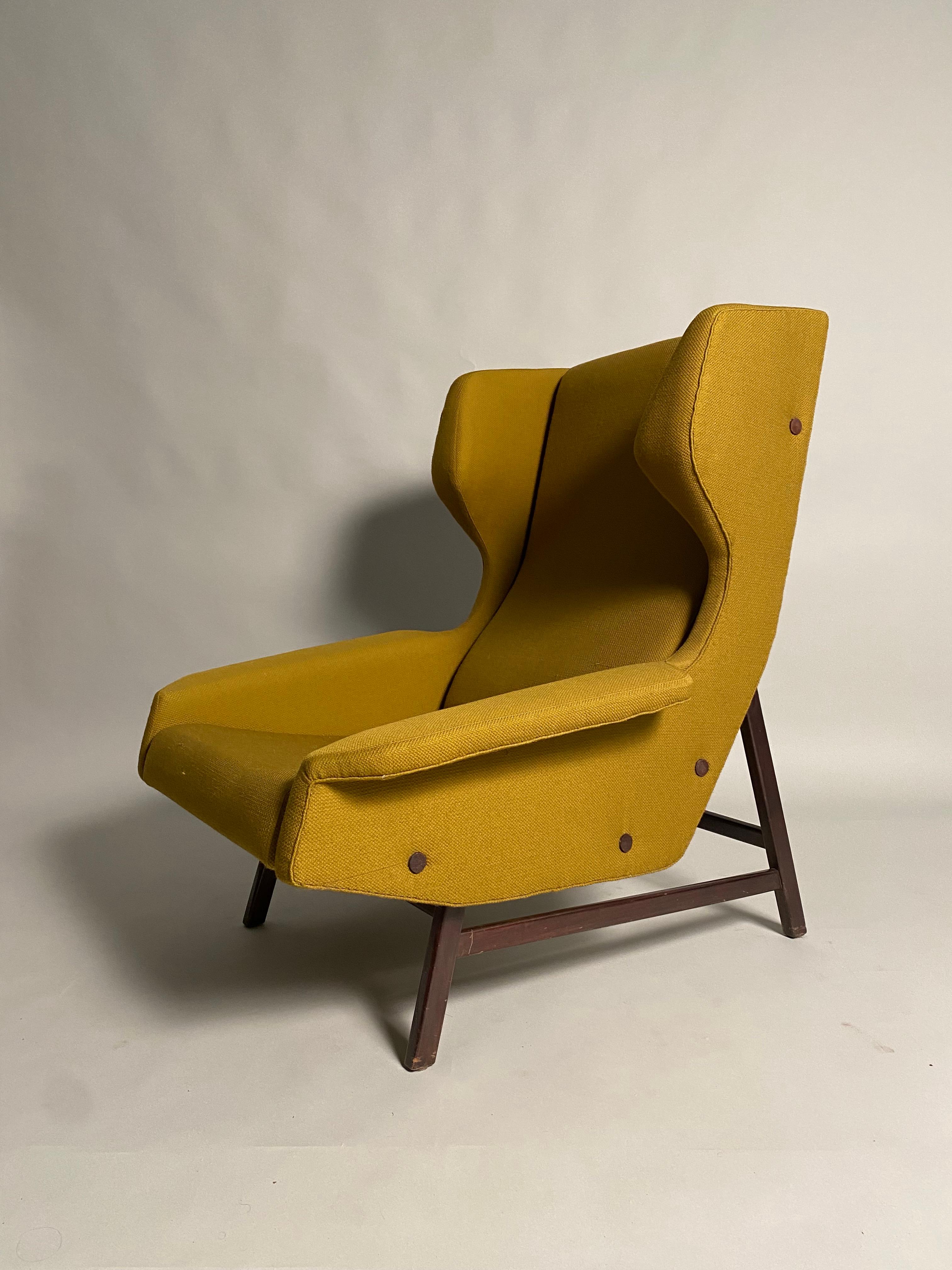 Rare pair of Wingback armchairs from an important chalet in the Italian Alps. Designed by the Italian Architect Gianfranco Frattini for the Cassina company in 1959. The fabric, in excellent conservation conditions, is still the original one selected