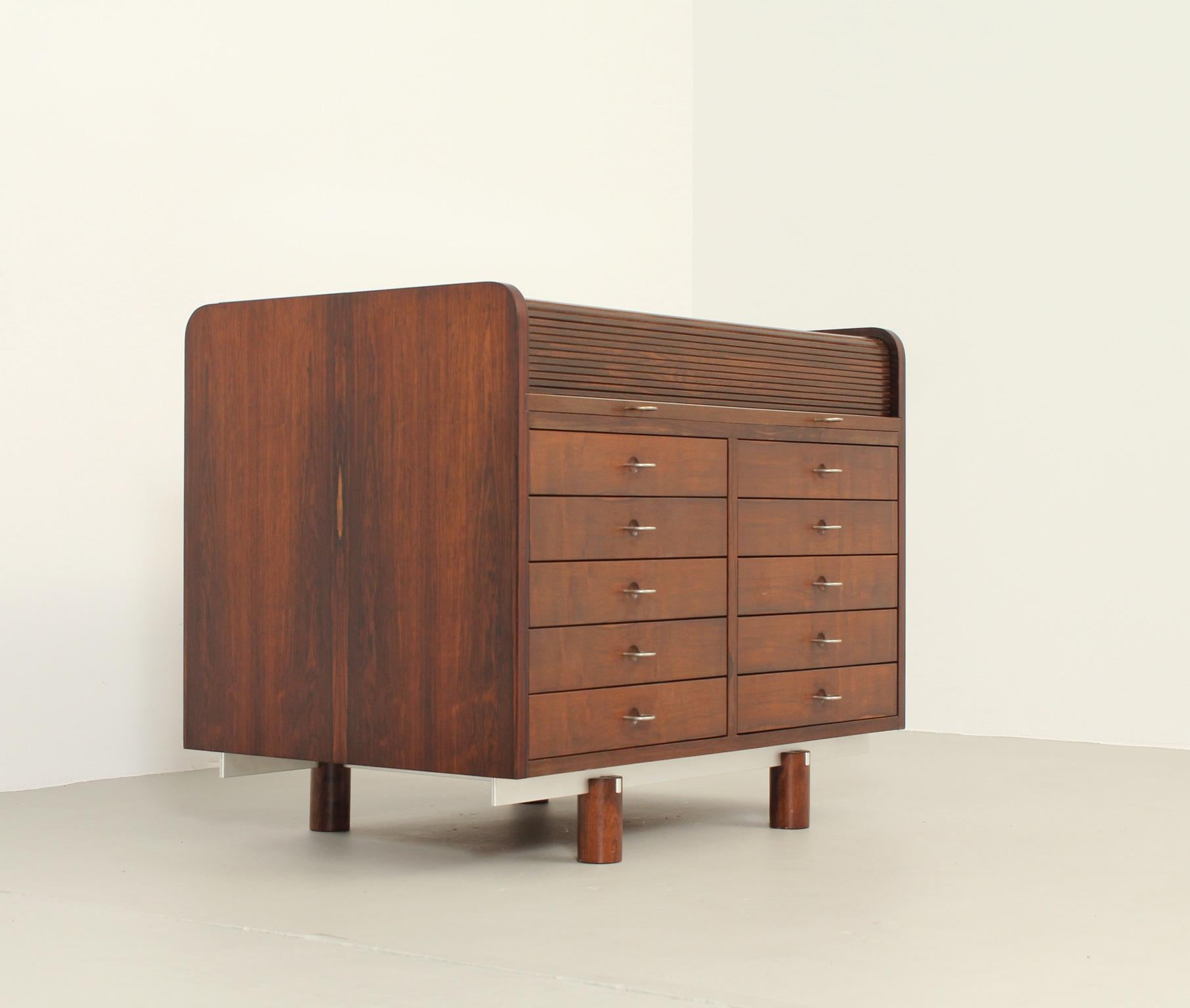 Writing desk model 804 designed in 1961 by Gianfranco Frattini for Bernini, Italy. Tambour top that hides small drawers and a pull out leather writing surface. Front side with ten drawers and four open spaces on back side.