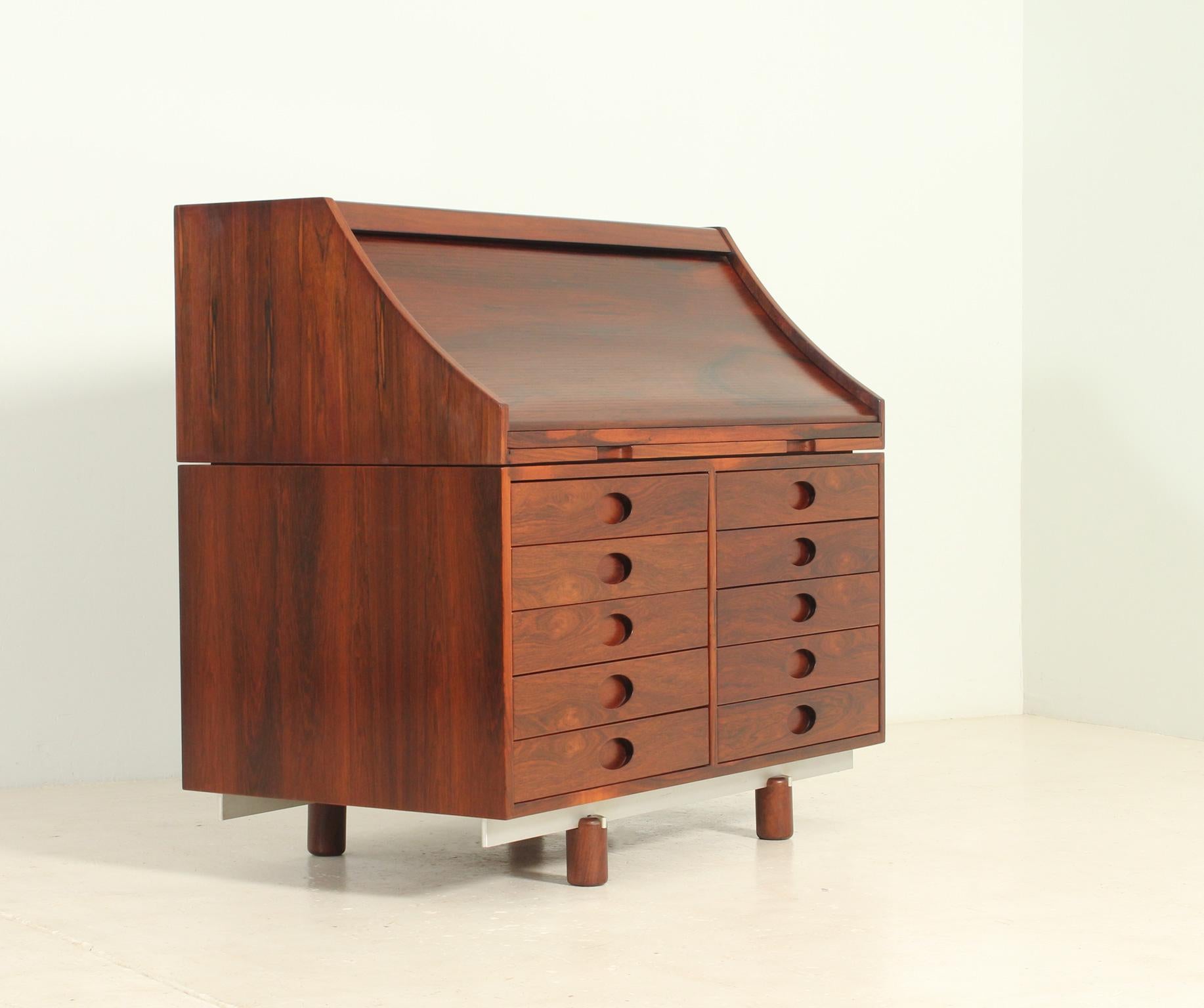 Writing desk model 807 designed in 1961 by Gianfranco Frattini for Bernini, Italy. Tambour top that hides small drawers and a pull out leather writing surface, ten drawers in the lower front side. Hardwood, aluminium and leather.