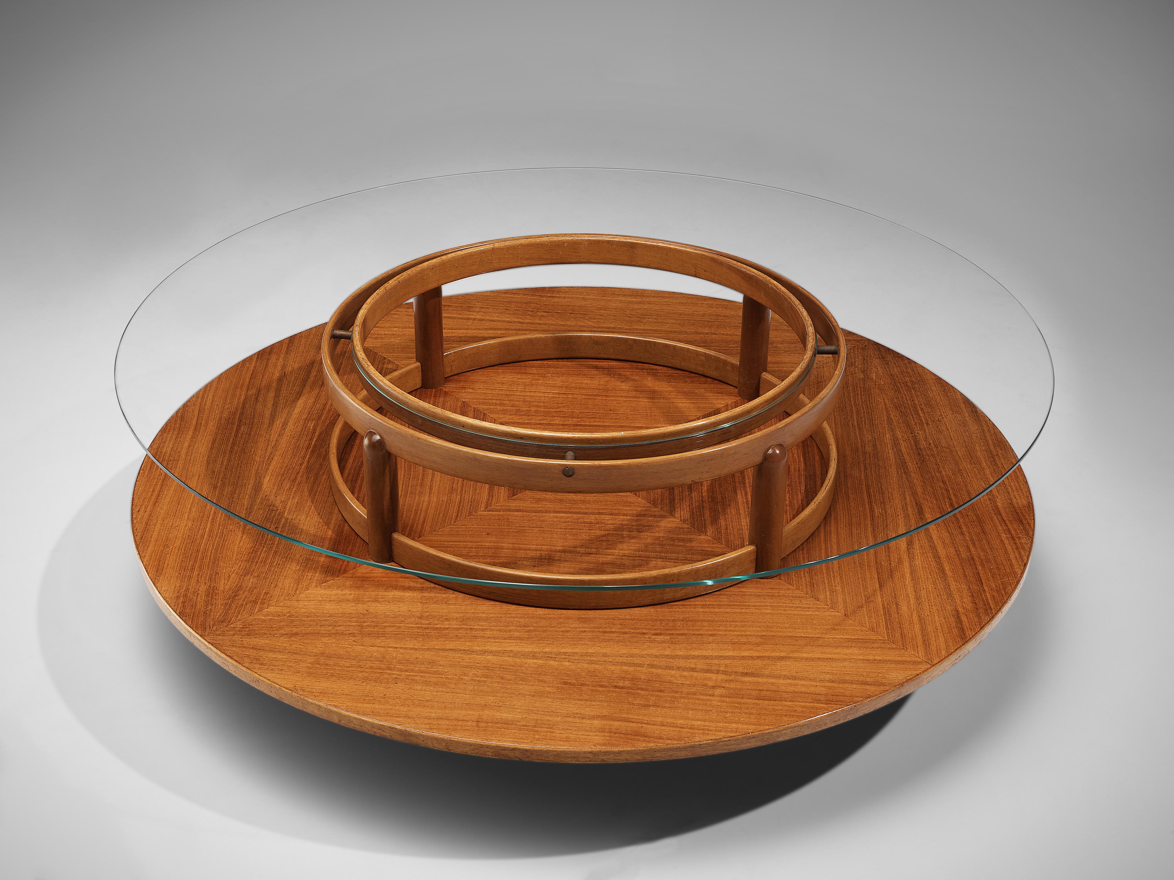Gianfranco Frattini for Cassina, round coffee table, walnut, glass, Italy, 1950s

This rare coffee table is executed within a well-proportioned construction based on a geometric layout. The circle is repetitive in every element, which contributes to