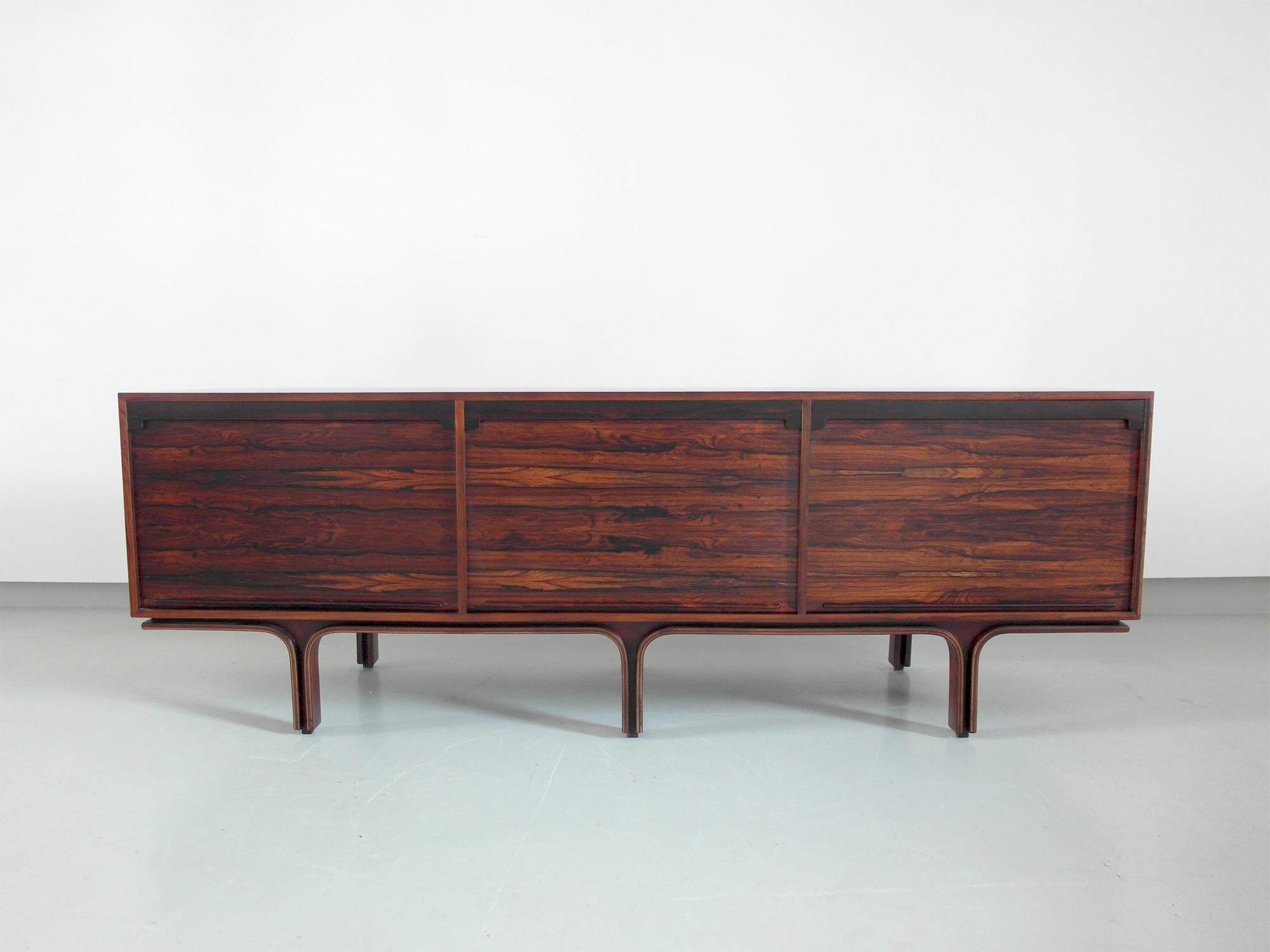 Italian sideboard with tambour doors designed by Gianfranco Frattini for Bernini, Italy, 1957. A beautifully designed Mid-Century Modern sideboard with three vertical tambour doors. The sideboard is executed in a magnificent flamed and grained wood