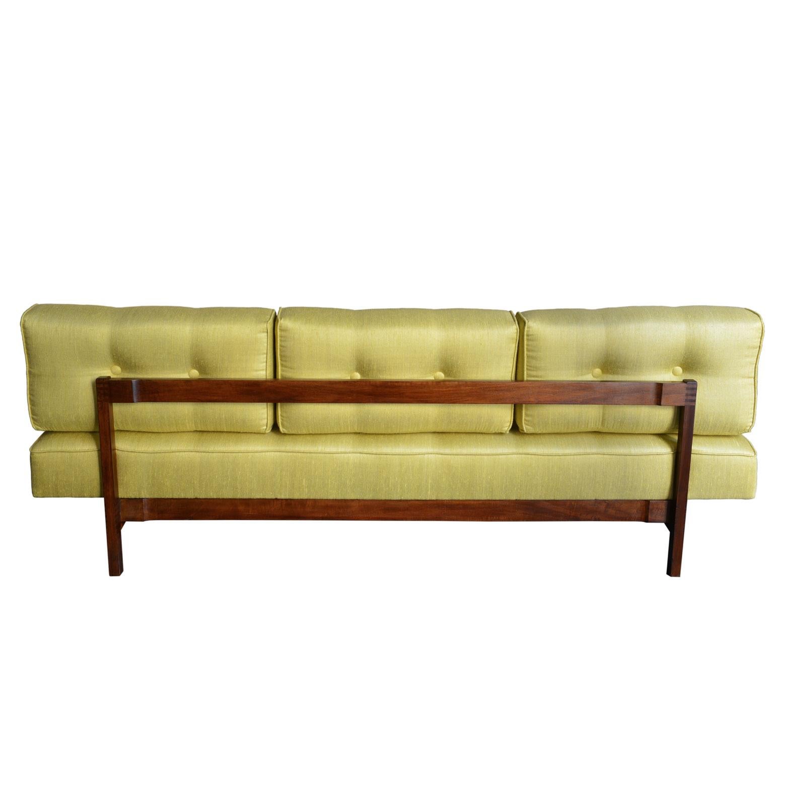 Sofa or daybed in walnut by Gianfranco Frattini. The original wooden structure has been newly reupholstered with a yellow silk shantung.