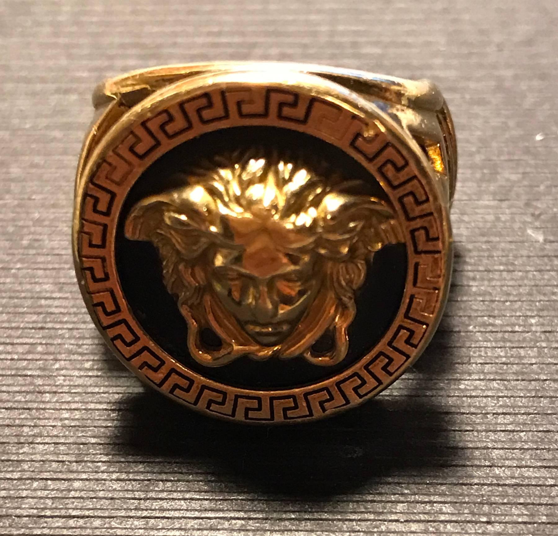 Signet 18k gold ring with the Medusa head over black enameled and a Greek fretwork carved all around as a frame. The ring has been professionally modified in the interior to fit a smaller finger, it consists of an extra inner gold ring welded to the