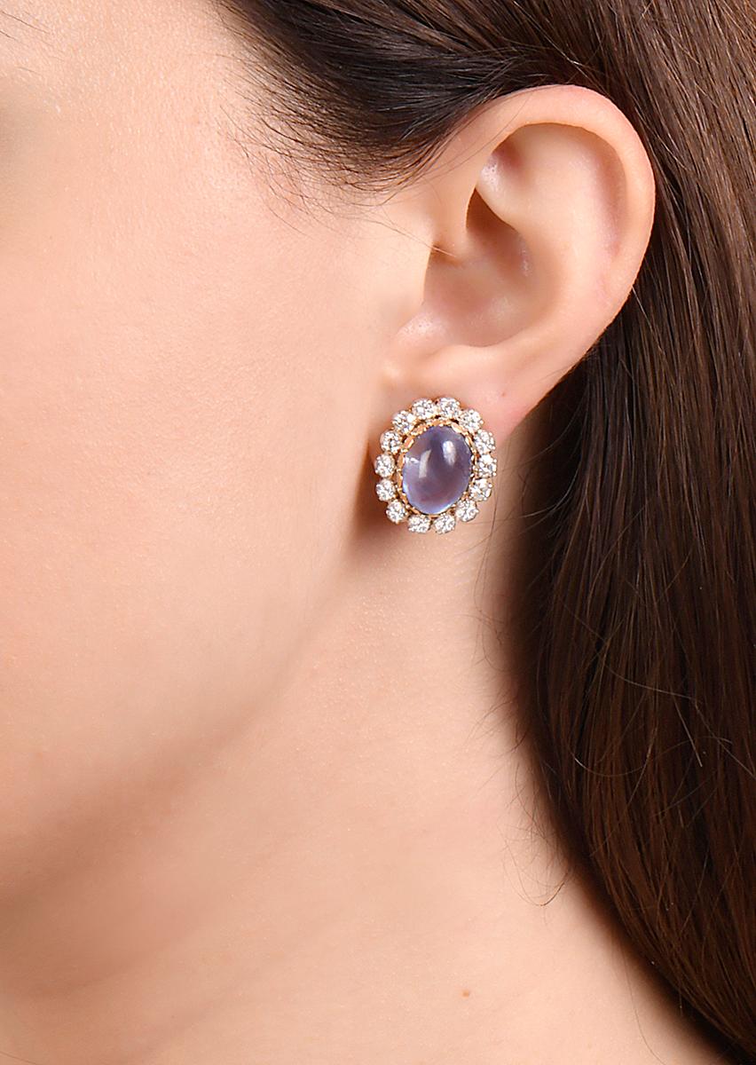These Gianmaria Buccellati ear clips feature two oval cabochon transparent blue Sri Lankan sapphires set in yellow, white and rose gold surrounded by round brilliant diamonds.  These Sri Lankan sapphires are free from heat treatment.  Respective