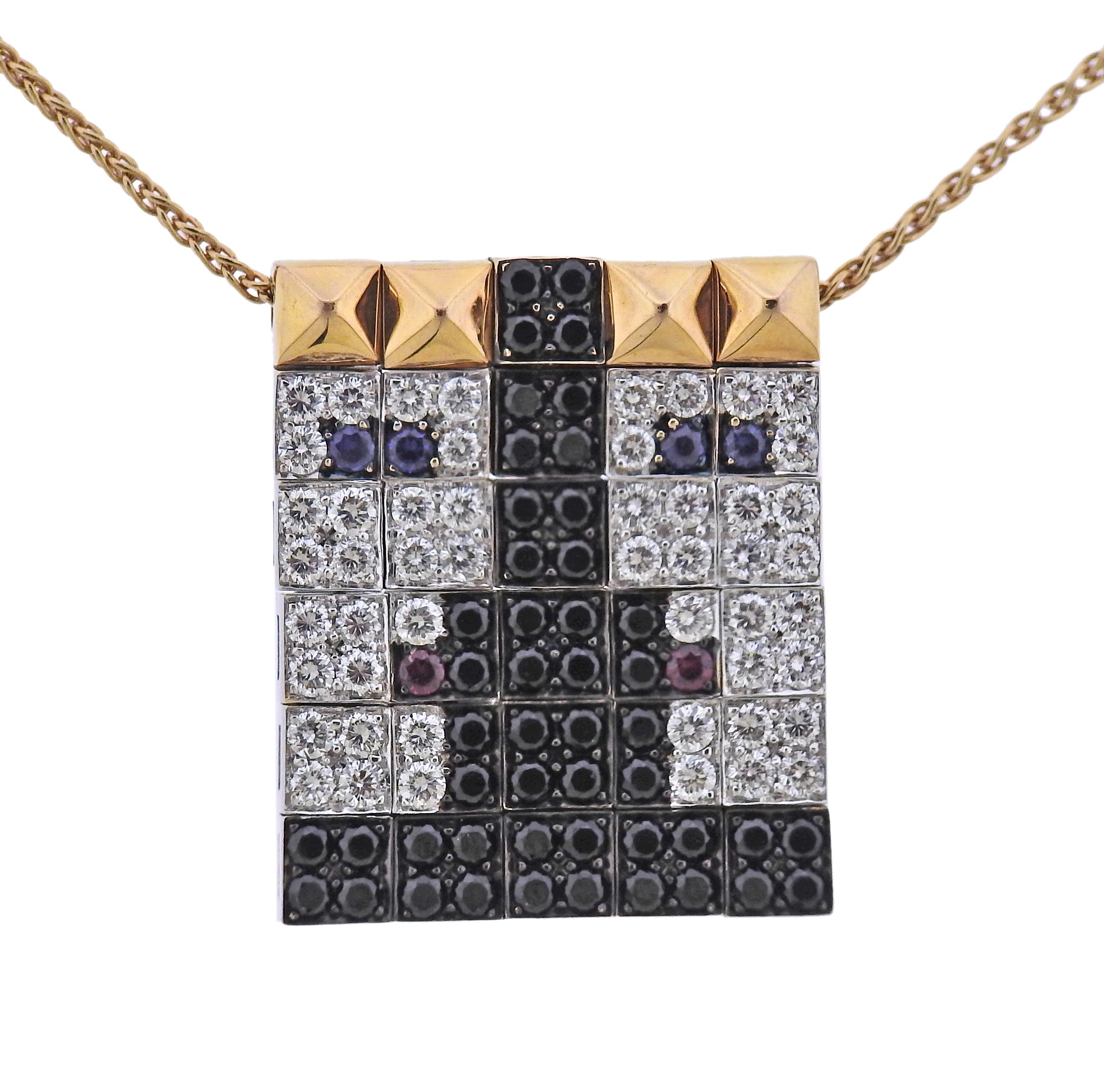 18k gold Enigma pendant necklace by Gianni Bulgari, with sapphires, rubies and approx. 1.10ctw in G/VS and black diamonds. Necklace is 16.5