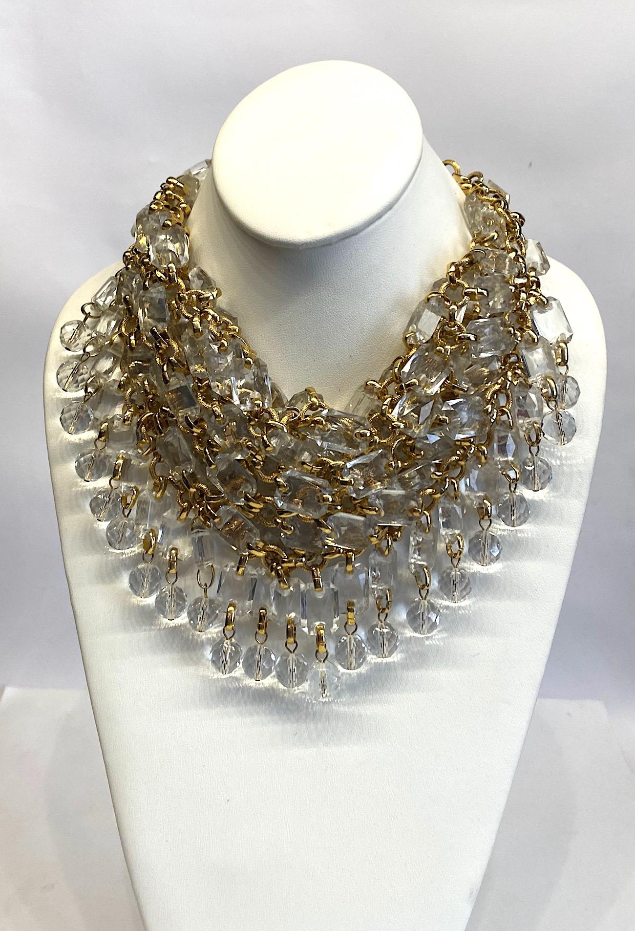 A fabulous and large 1980s handkerchief style bib necklace by Italian fashion jewelry designer Gianni De Liguoro. The necklace is comprised of two layers of emerald cut faceted .5  by .75 of an inch lucite stones and .5 inch diameter faceted crystal