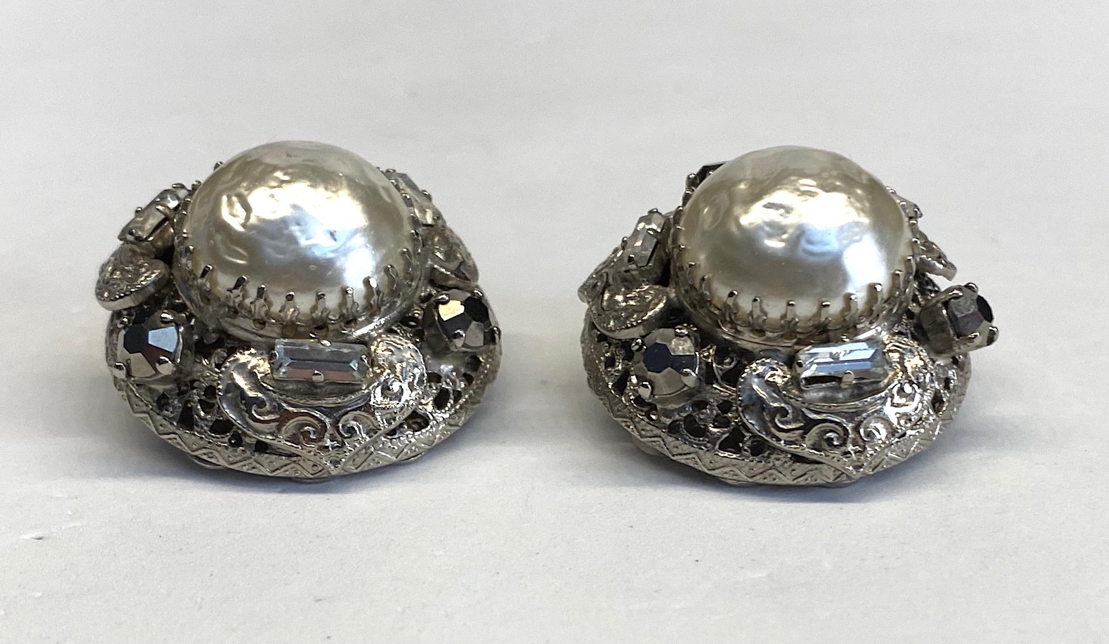 A beautifully made pair of unsigned Gianni De Liguoro large button earrings. The earrings are hand constructed with a dome shape front and a lace disk back. The use of the openwork lace findings are typical and unique of De Liguoro construction.