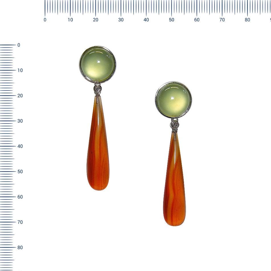 Earrings White Gold 18 K Gianni Lazzaro 

Diamonds 2-0,14 ct GSI 
Prenit 2 Cabochon -16,37ct
Carnelian 2 Cabochon-48,56ct
Weight 19.80 gram

With a heritage of ancient fine Swiss jewelry traditions, NATKINA is a Geneva based jewellery brand, which