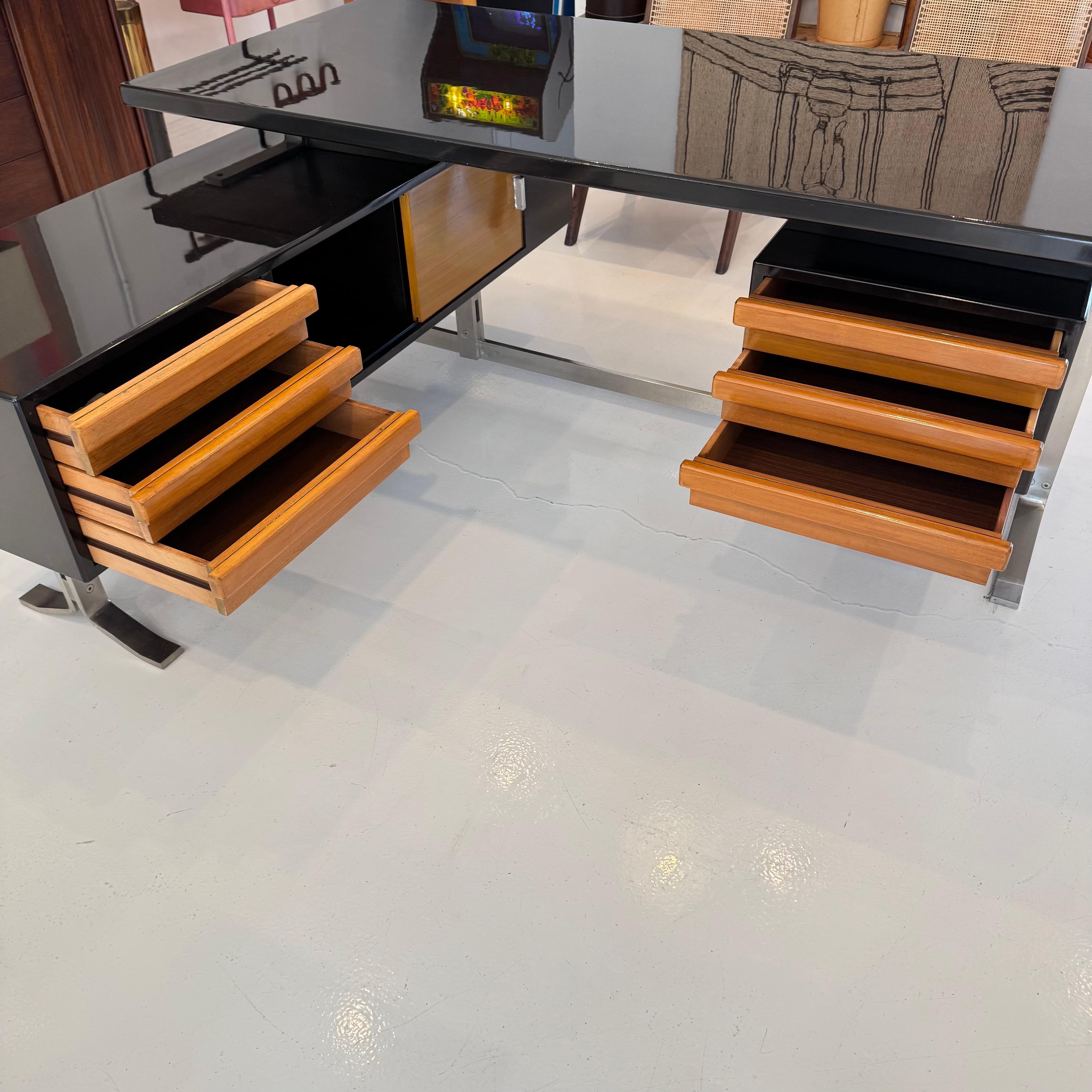 Stunning Formanova desk by Gianni Moscatelli. Original Formanova tag dated and signed 1979, Italy. Newly refinished in a high gloss Ebony polished finish. Right side of desk has a floating pedestal with three pull-out drawers refinished in a caramel