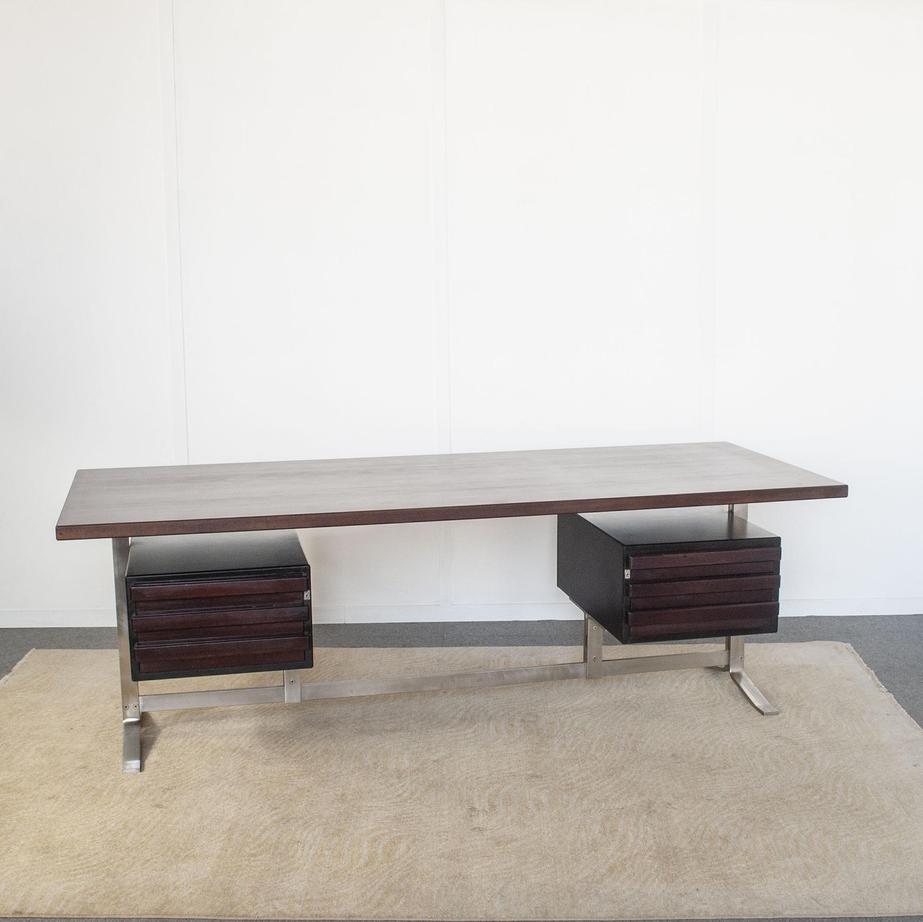 Desk design by Gianni Moscatelli for Formanova 1970s. Palisander desk surface rests on flat stainless steel legs with floating drawers on either side. Original locks without keys.