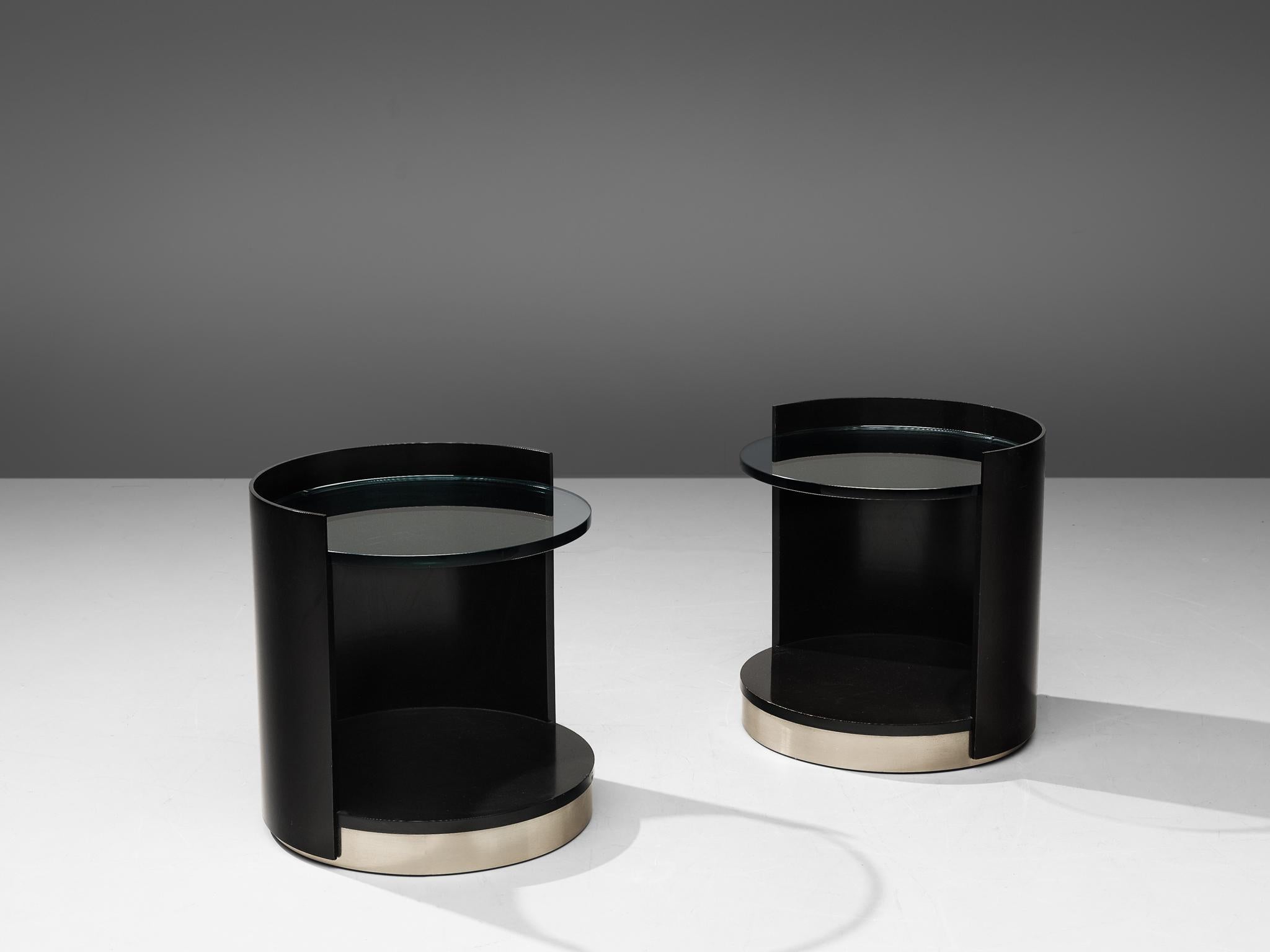 Gianni Moscatelli for Formanova, pair of side tables, wood, glass and metal, Italy, 1970s

Postmodern pair of nightstands by Gianni Moscatelli for Formanova. The tables have a cylindrical shape, featuring a black lacquered wood frame that's open on