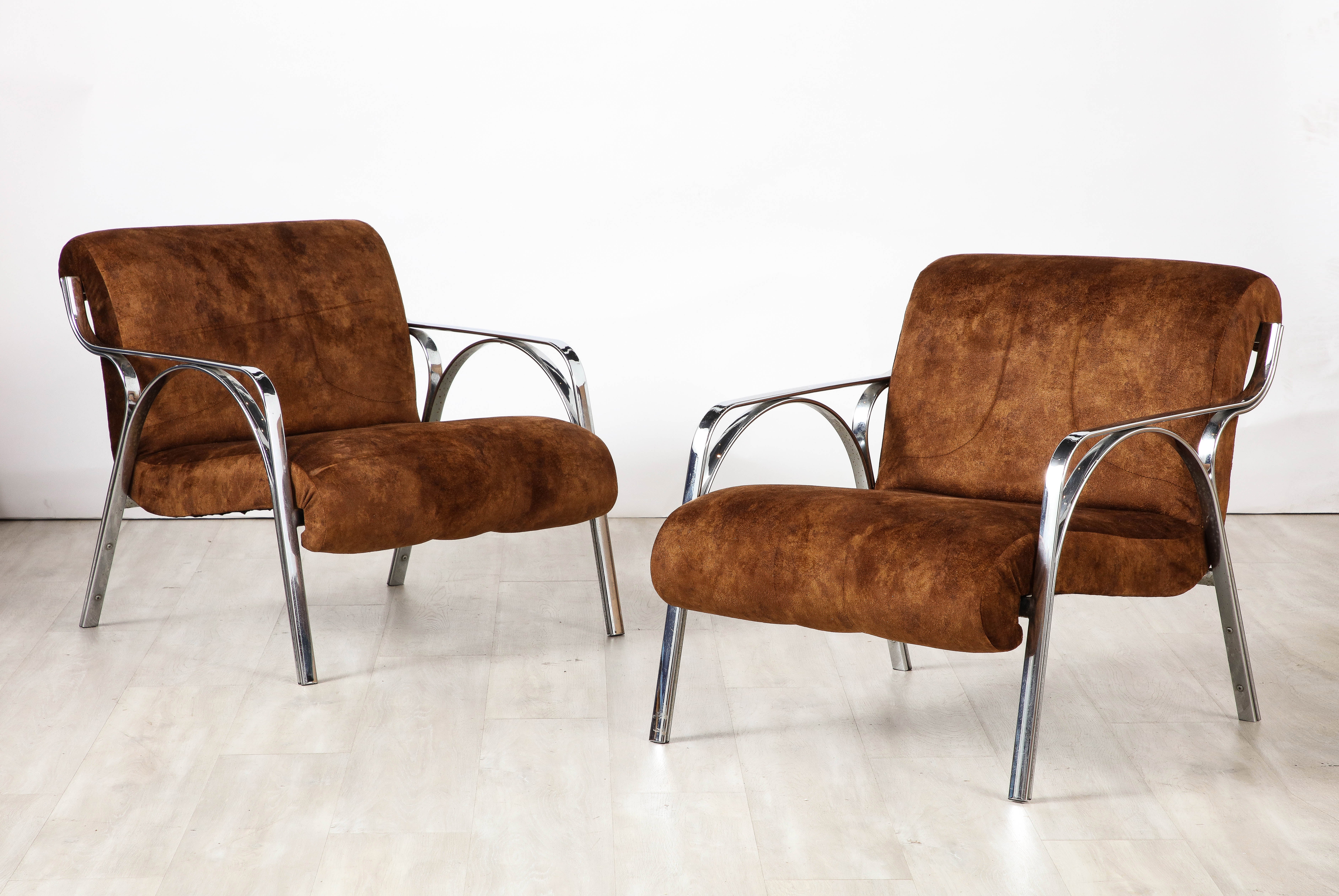A pair  of lounge chairs / armchairs by Gianni Moscatelli, for Formanova, 1970's. 
The chairs display a sleek and sinuous shaped chrome design for which Moscatelli was known. Newly re-upholstered in a chocolate brown Ultrasuede, which mimics the