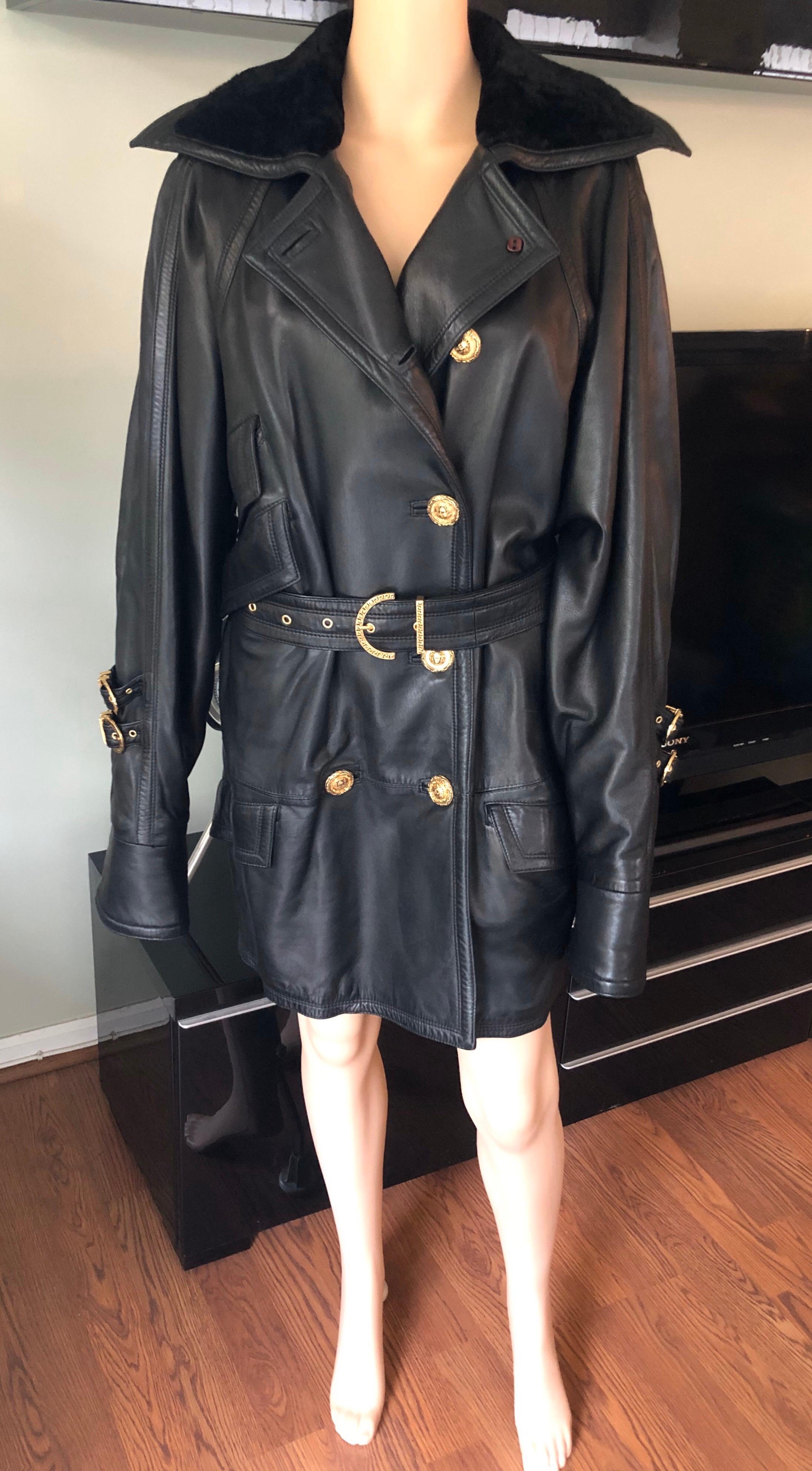 Gianni Versace c. 1990 Bondage Leather Belted Knee-Length Black Jacket Coat IT 44

Black Gianni Versace leather knee-length coat featuring four flap pockets at sides, buckled belt and double-breasted button closures at front.
