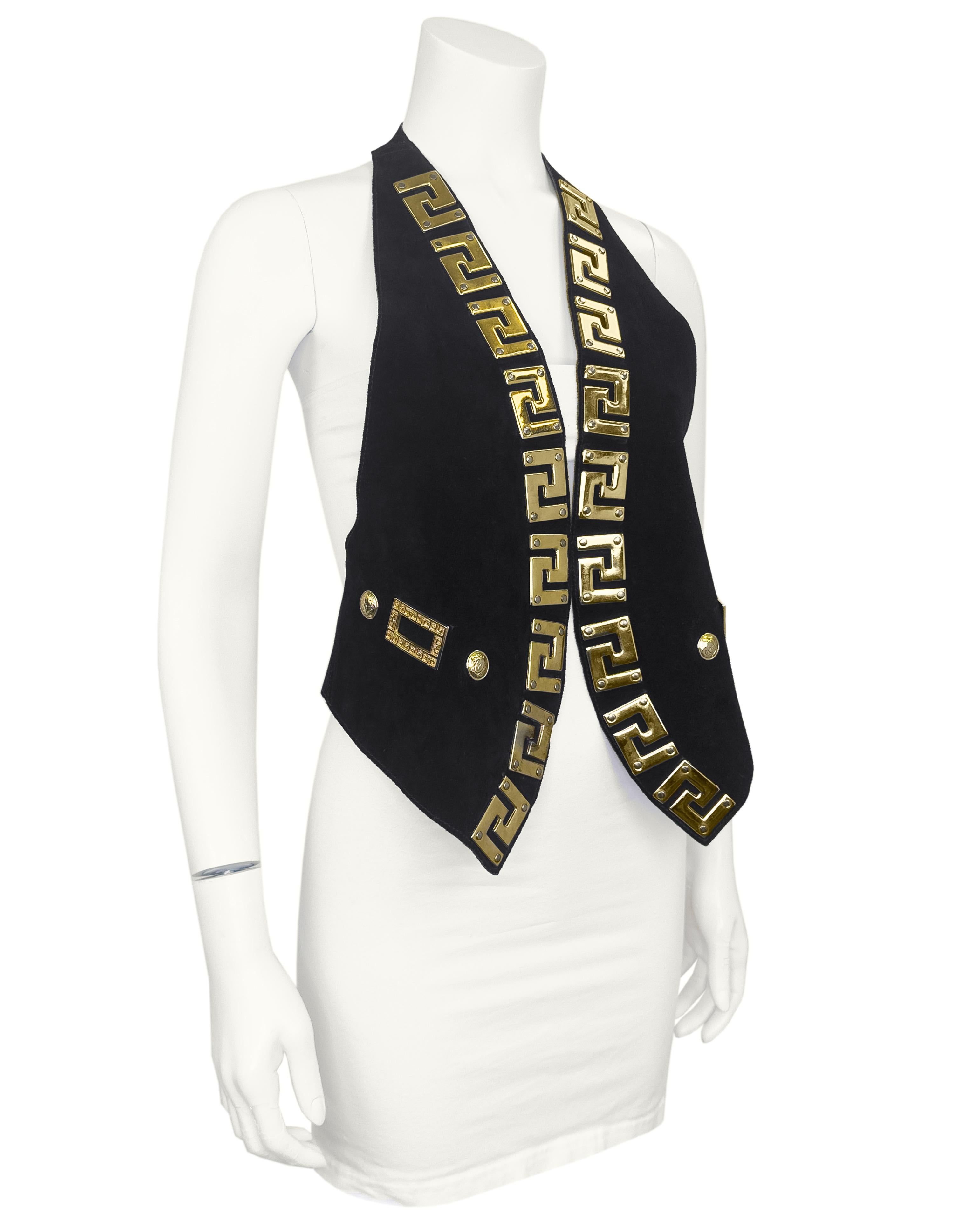 GIANNI VERSACE 1990s black suede leather halter-style backless vest style top with open front.
Decorated with iconic gold metal medusa buttons and Greek key meandros. 

Adjustable waist back with hardware snaps. Can fit many sizes, length: 25