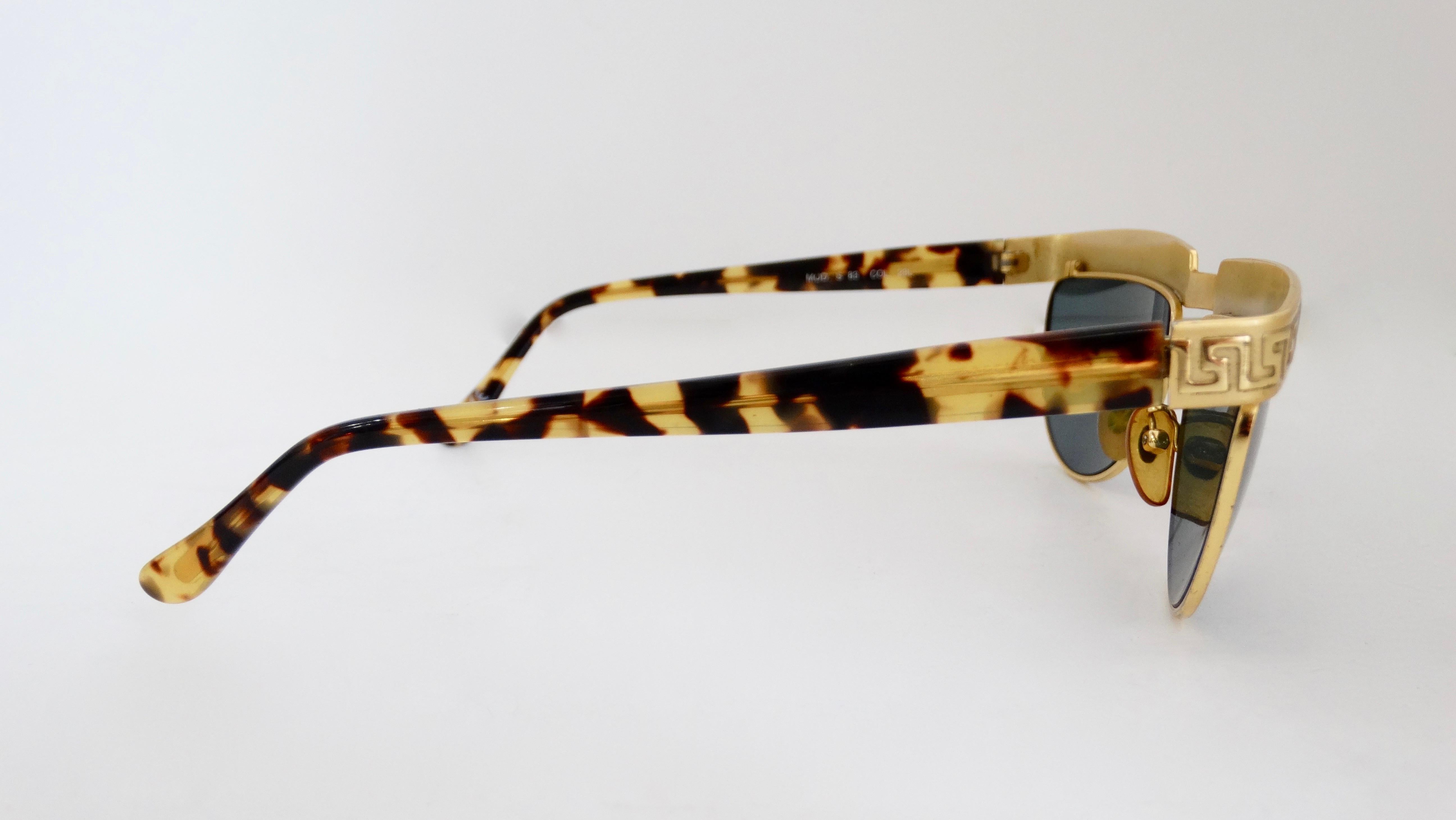 Add a statement to your sunglasses game with this amazing Gianni Versace sunglasses! Circa 1990s, these sunglasses feature a half circle shape with gold hardware, dark lenses and tortoise shell arms. Lining the gold bridge is the iconic Versace