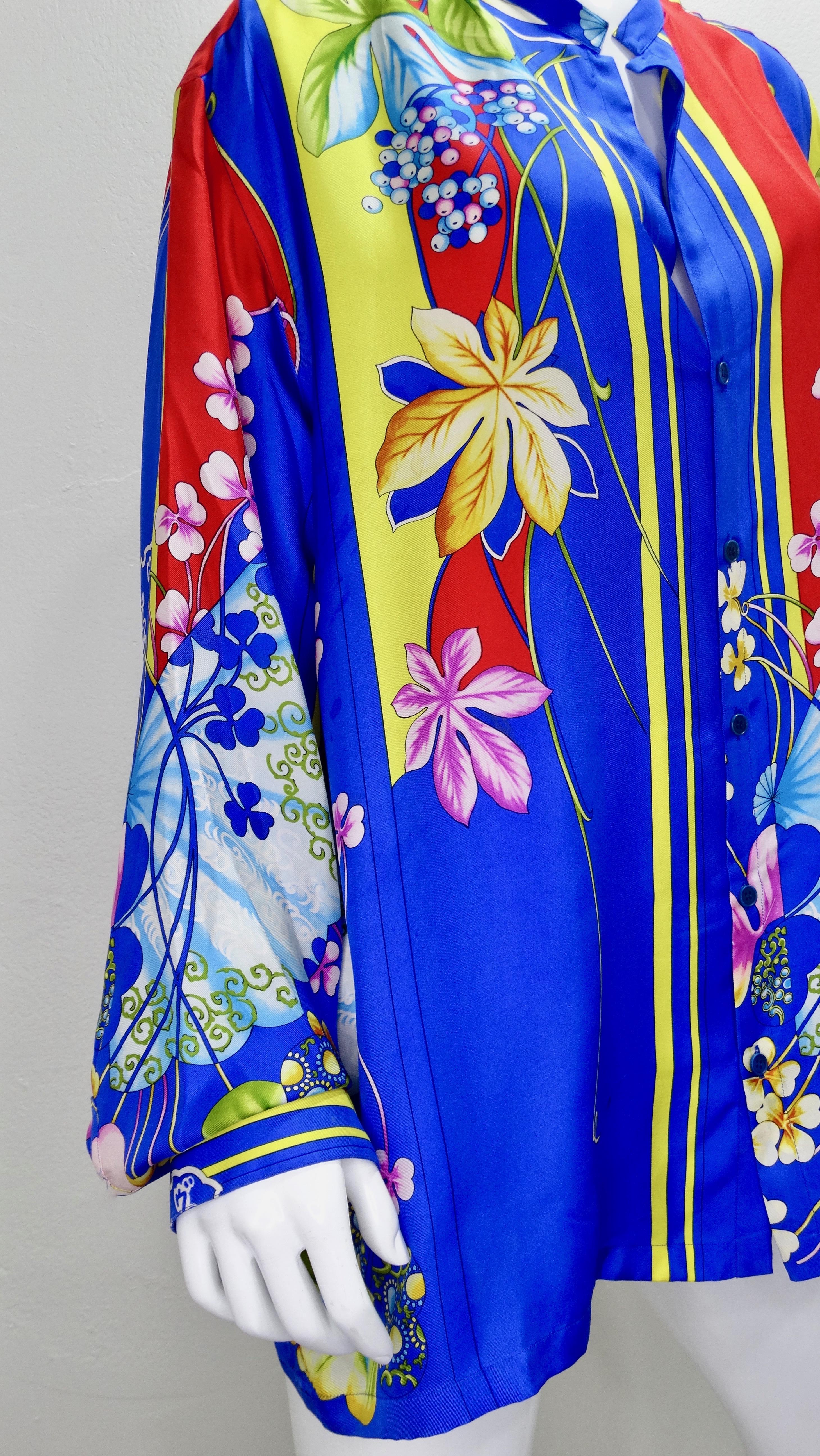 Snag yourself a piece from the Versace archives! Circa 1990s, this colorful Silk button down shirt features a vibrant Japanese inspired motif with flowers/plants indigenous to Japan, traditional folding fans, and Japanese symbols. Includes a button