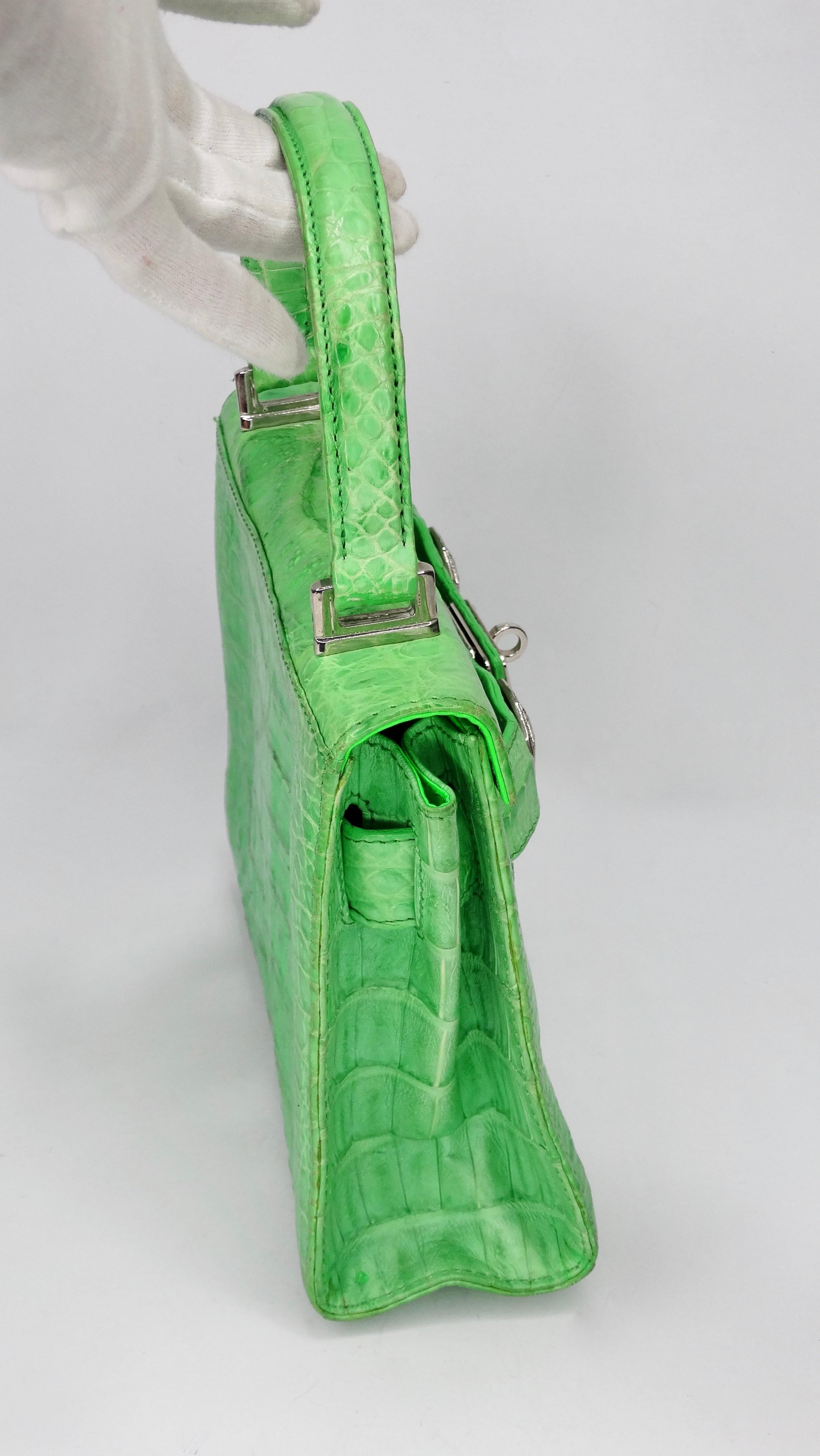 Accessorize in style with this Gianni Versace bag! Circa 1990s, this mini handbag is crafted from crocodile with a lime green finish and features a single flat top handle, silver hardware, a detachable shoulder strap and a Hermes Kelly style front