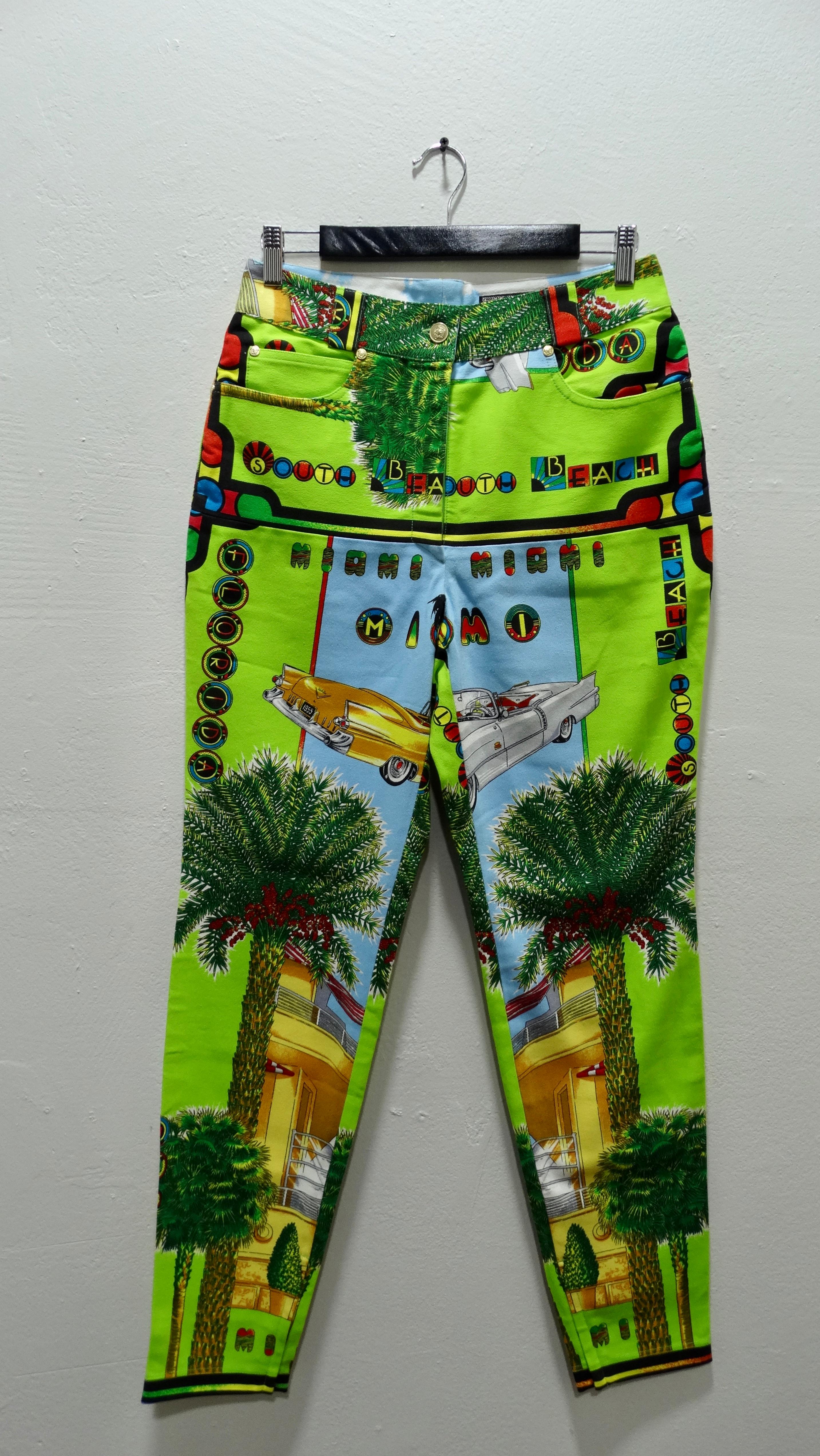 Feel that Miami heat in these show stopping jeans by Gianni Versace Couture! Circa 1990s, these statement pants will surely turn heads and be the perfect addition to your wardrobe this summer! This print features neon colors and iconic Miami emblems