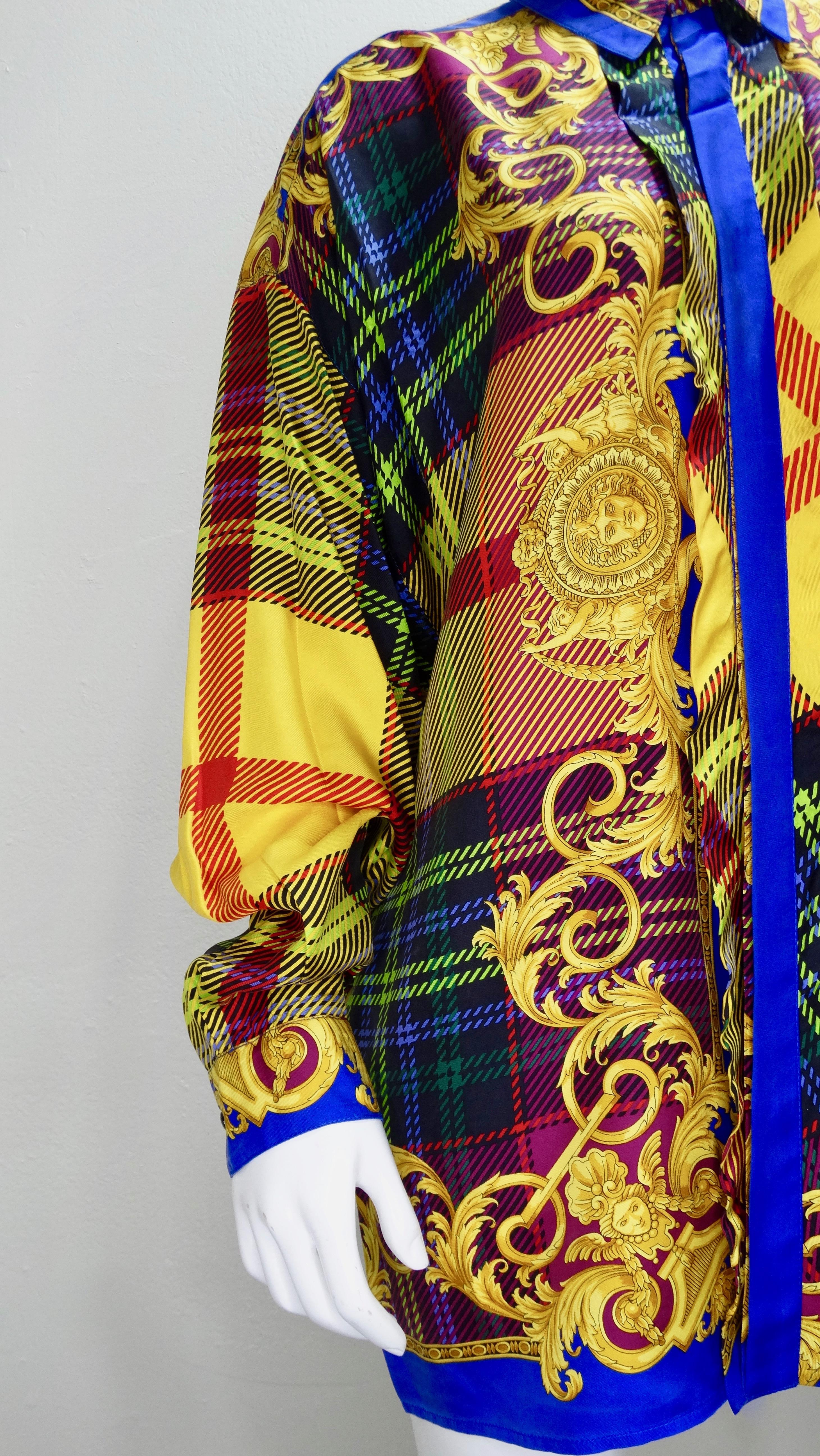Gianni Versace 1990s, this colorful Silk button down shirt features a layered multi-colored plaid print mixed with Versace's signature Baroque designs and Medusa heads. Includes a hidden button closure down front, classic collar and faceted buttons
