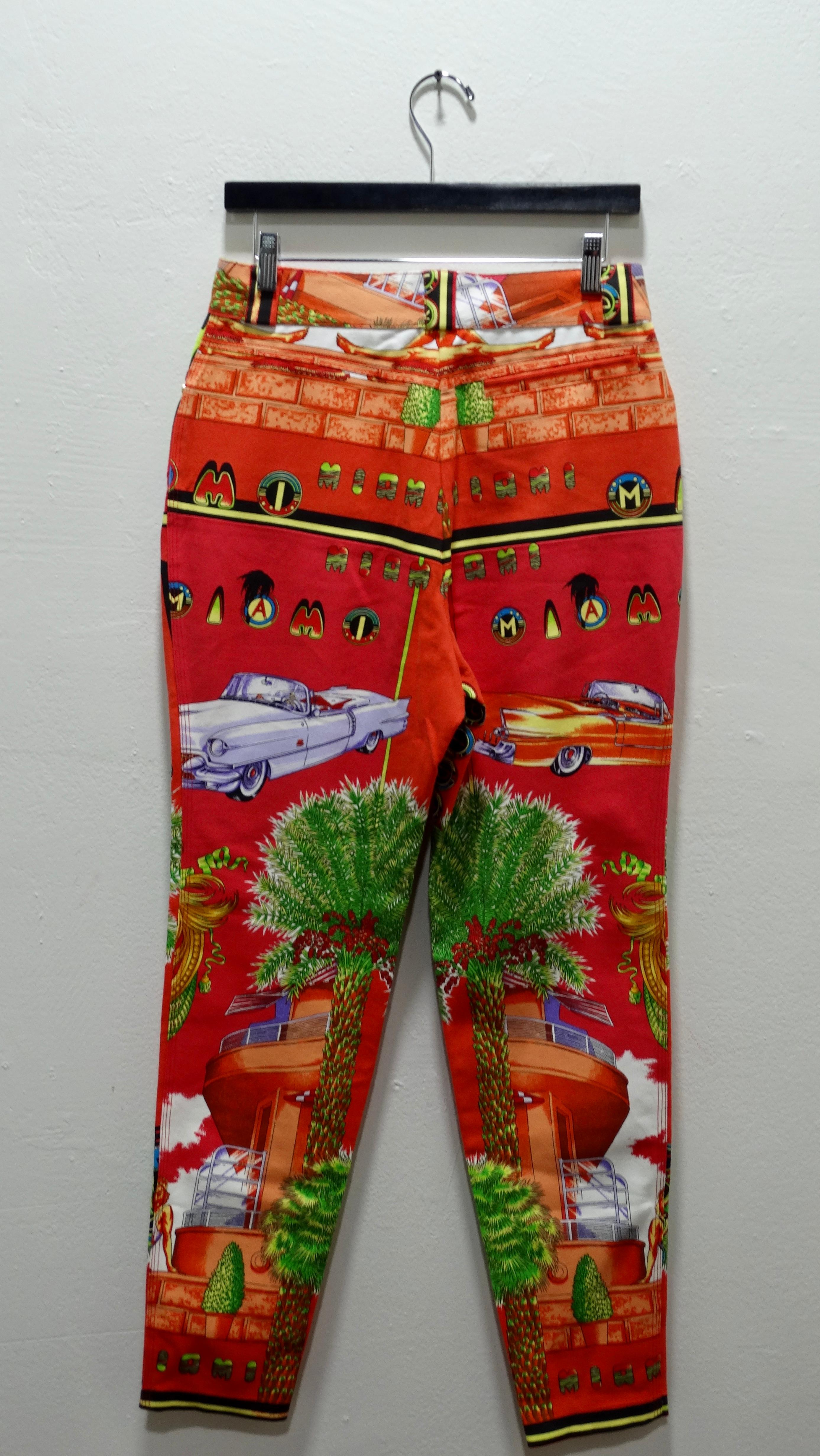 How hot are these jeans?! Sizzle all summer long in these red/orange Miami print jeans by Gianni Versace spring/summer 1993. Featuring a stunning red and orange base with iconic South Beach Miami emblems throughout. These jeans feature a zip fly and