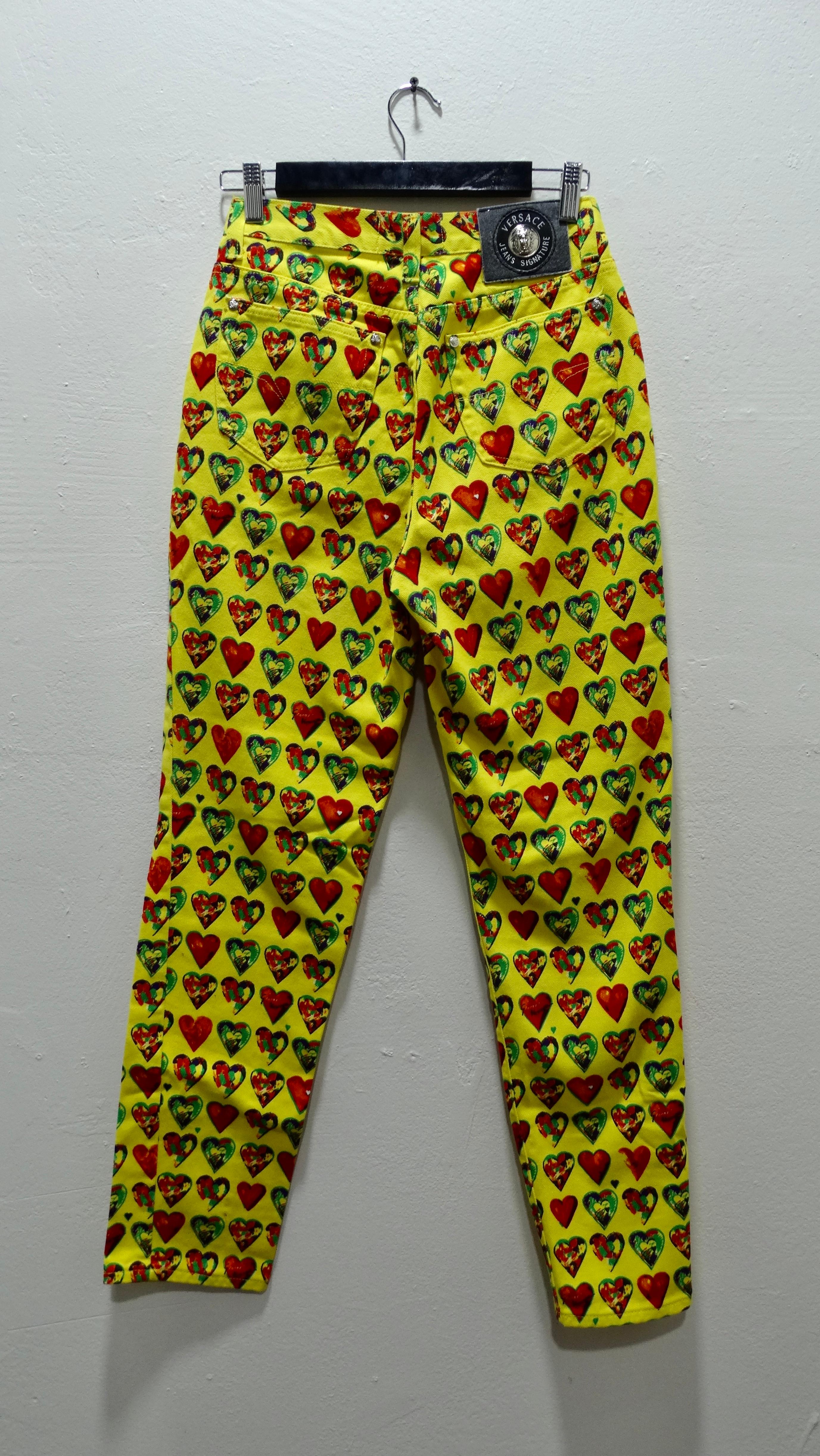 Heart eyes for these funky jeans! From 1997, these bright yellow boyfriend style jeans feature a colorful hearts motif that Gianni commissioned from the artist Jim Dine for his New York residence. This print became iconic and was featured again on