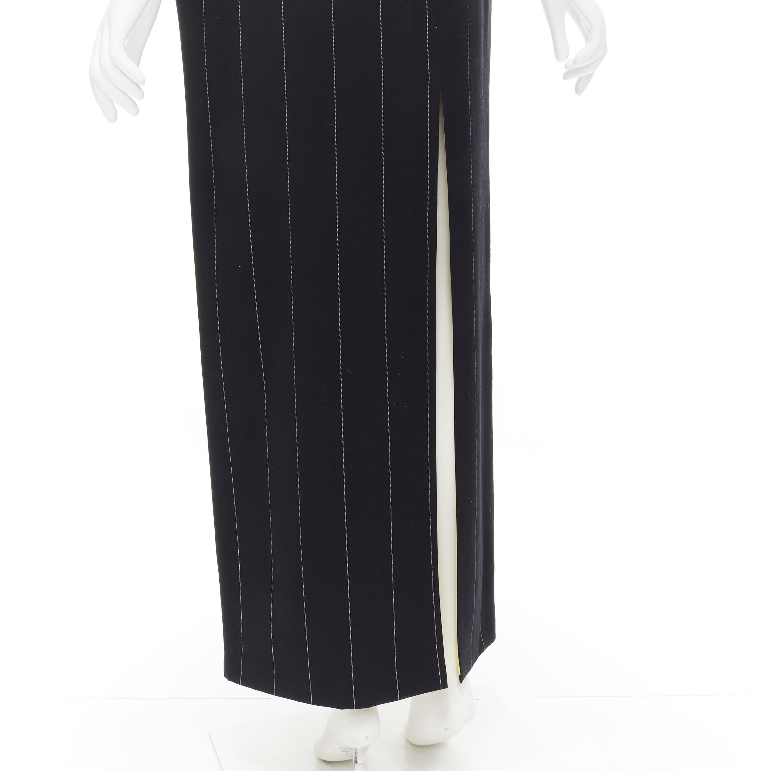 GIANNI VERSACE 1998 Vintage black wide pinstriped wool high slit skirt FR40 M 
Reference: GIYG/A00127 
Brand: Gianni Versace 
Material: Wool 
Color: Black 
Pattern: Striped 
Closure: Zip 
Extra Detail: Black with white stripes. Contrast yellow rayon