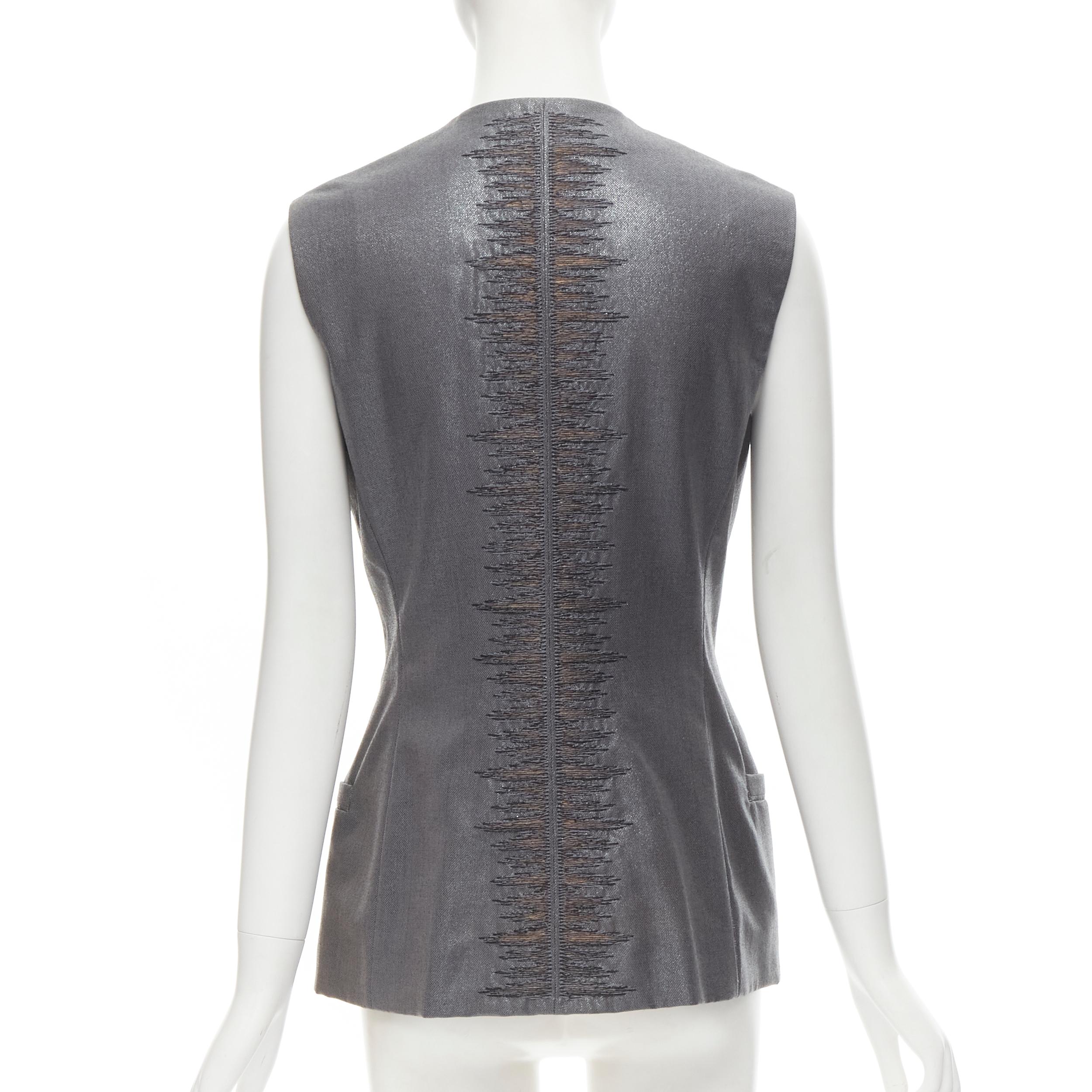 GIANNI VERSACE 1998 Vintage metallic silver lurex embroidered back vest 
Reference: GIYG/A00188 
Brand: Gianni Versace 
Collection: 1998 
Material: Wool 
Color: Silver
Pattern: Solid 
Closure: Zip 
Extra Detail: Concealed zip snap button. Metallic