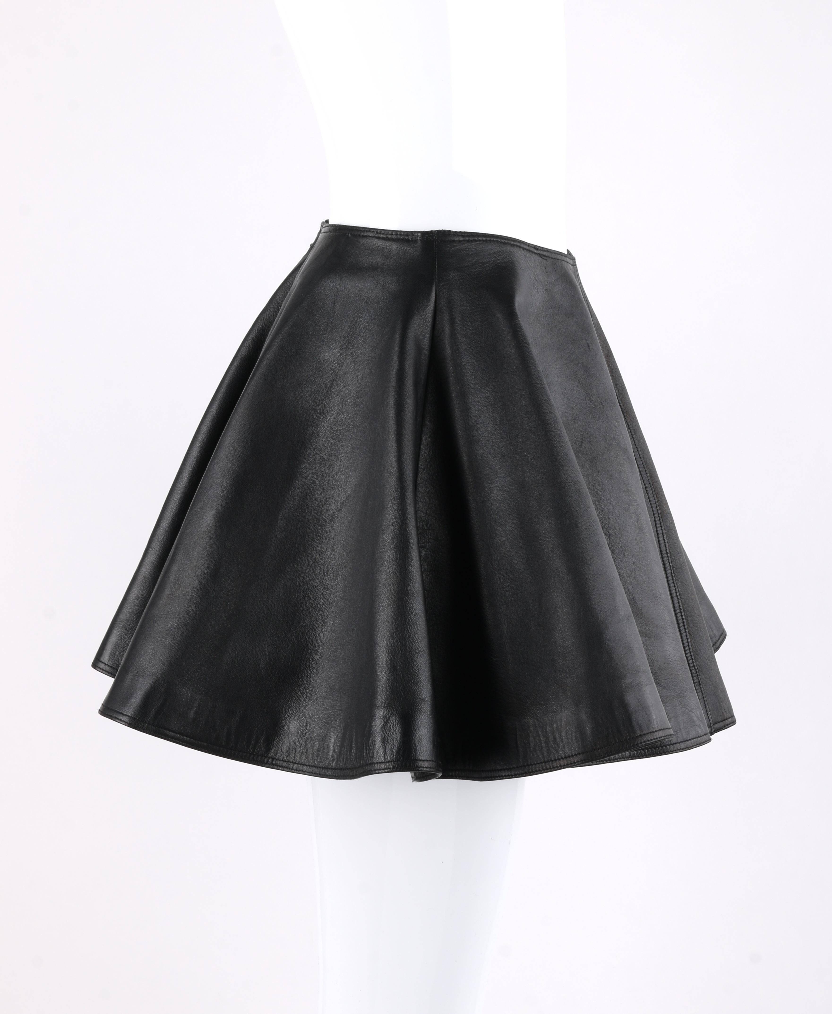GIANNI VERSACE A/W 1994 Black Leather A-Line Micro Mini Circle Skirt
 
Collection: Autumn / Winter 1994
Brand / Manufacturer: Gianni Versace
Designer: Gianni Versace
Style: Micro-mini skirt
Color(s): Black 
Lined: Yes
Marked Fabric Content: “100%