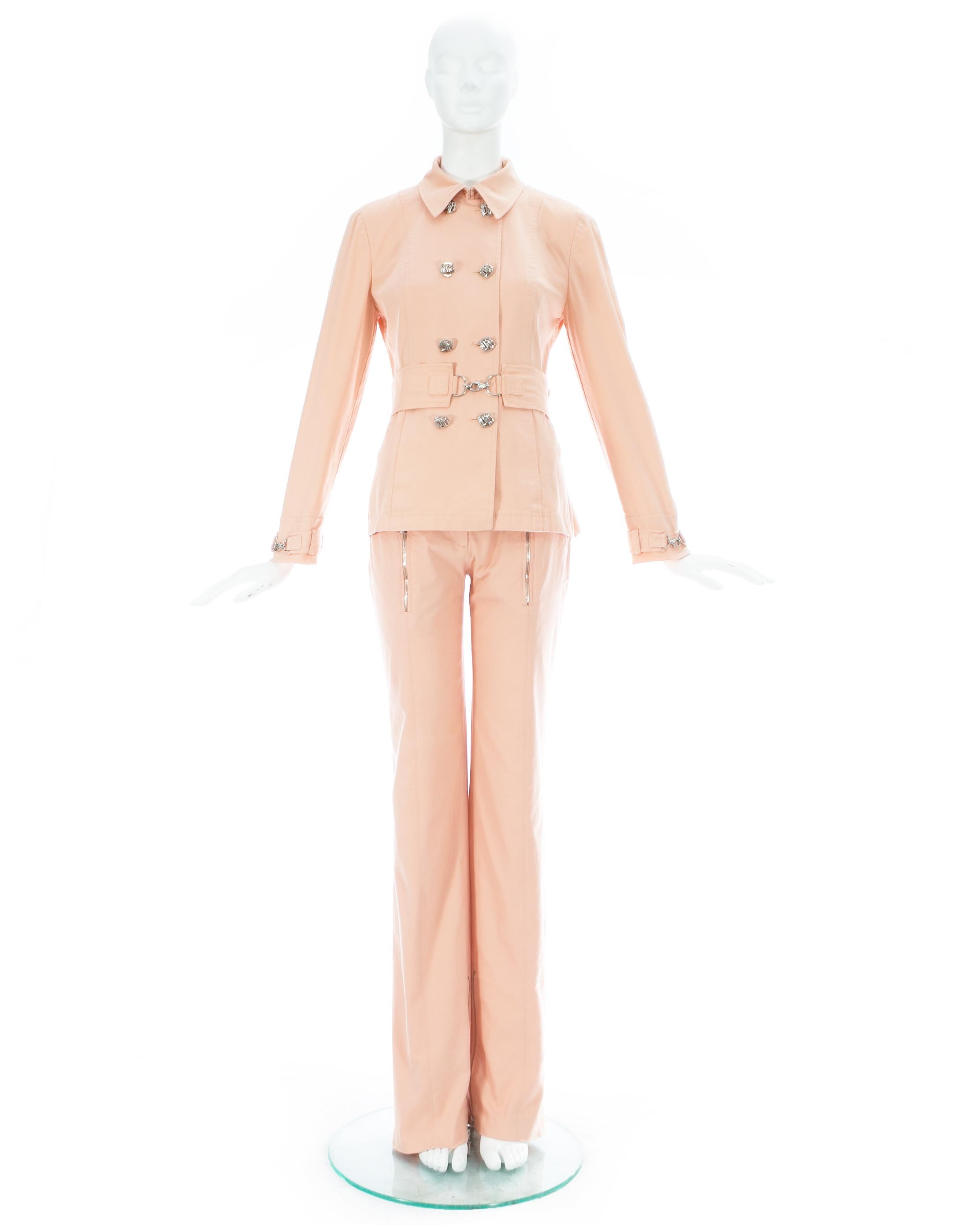 Gianni Versace; Baby pink cotton pant suit, includes a double breasted fitted jacket with matching waist belt and slim fitted long pants with zip openings on the ankles. 

Spring-Summer 2003