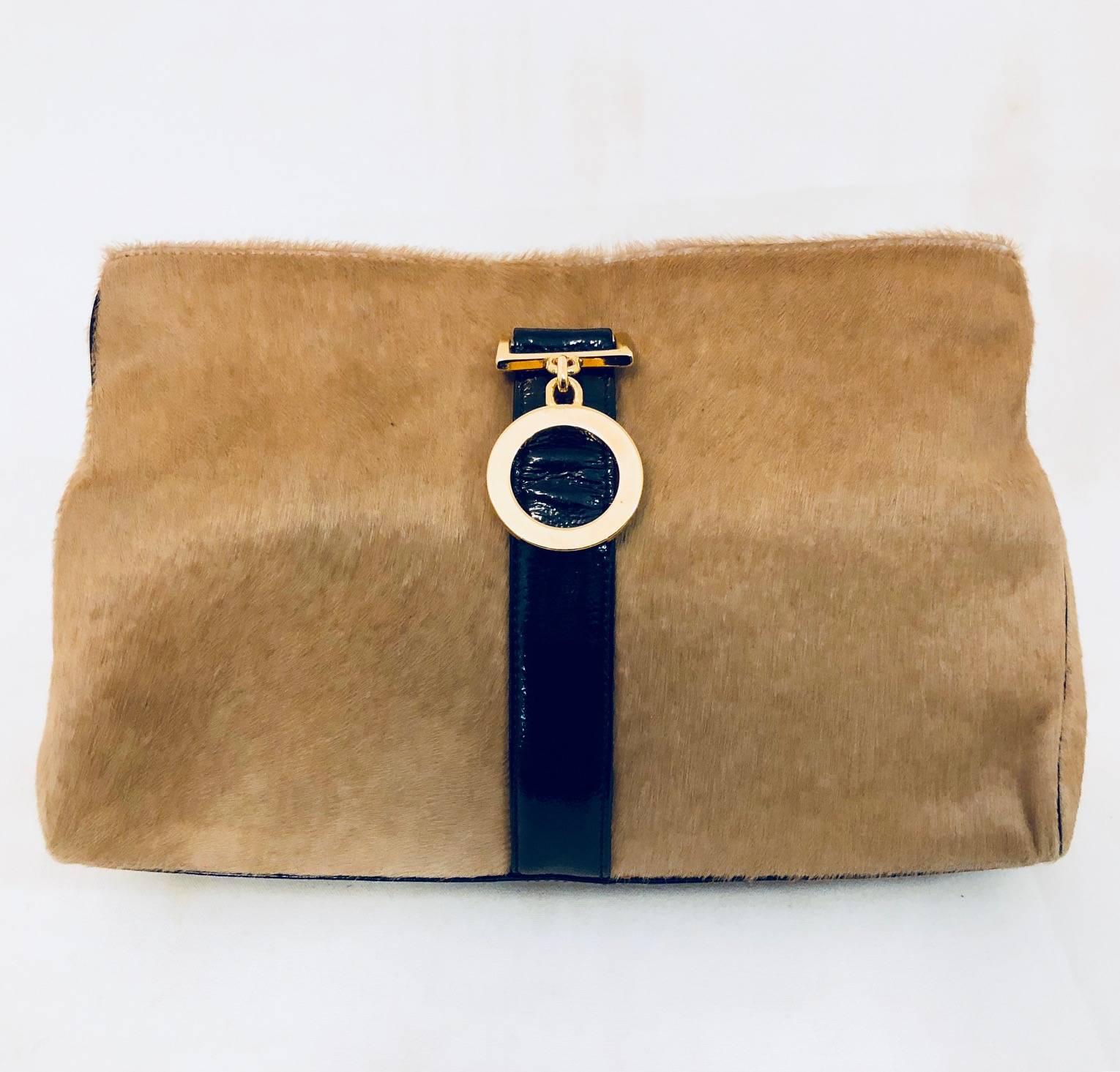 This innovative Gianni Versace clutch is made of beige pony hair and black patent leather trim.  Timeless, yet modern design, features a sophisticated, sleek shape that allows easy access.  To close, just roll the top over and close the bag with the