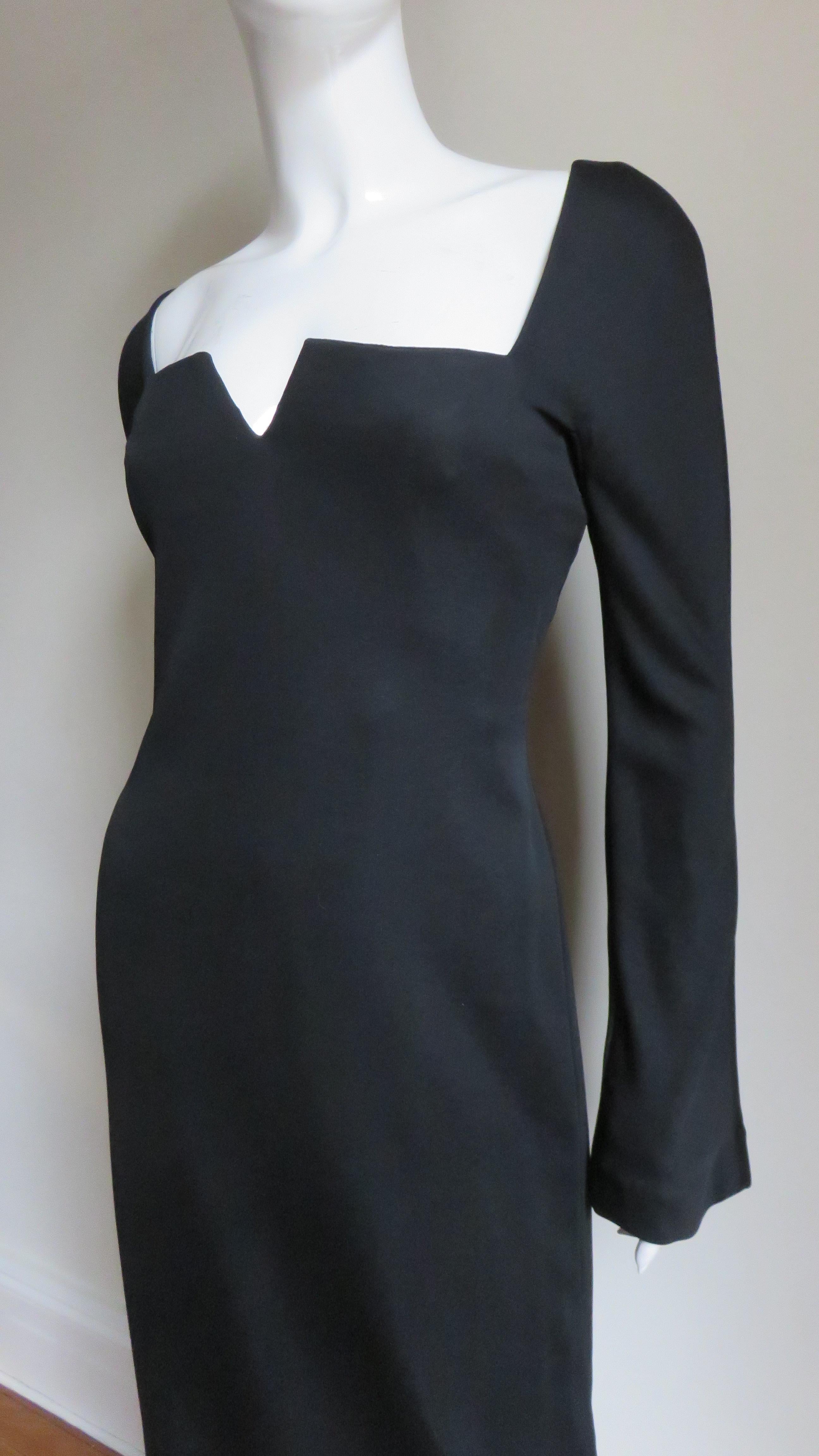 A fabulous black silk jersey dress from Gianni Versace. It has a square neckline with a notched center and long subtly belled sleeves. The dress is semi fitted with inner boning for support, a back zipper and it is unlined.
Fits sizes Small, Medium.