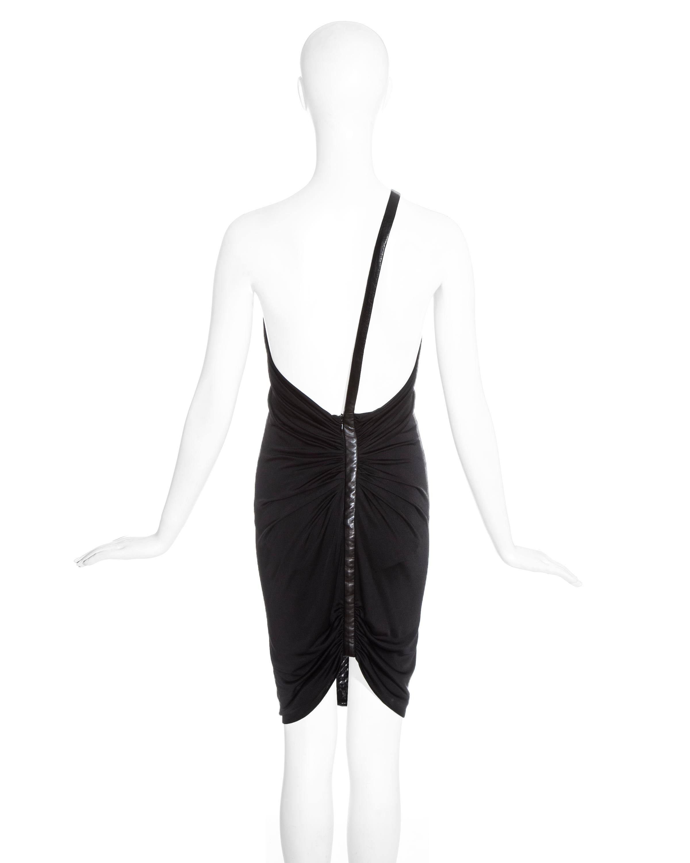 One-shoulder black dress with leather strap and gathers at strap on front and back. 

Spring-summer 2001