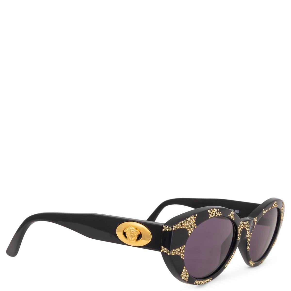 100% authentic Gianni Versace vintage sunglasses in black acetate with gold-tone glitter pattern and gold-tone Medusa on the side. Grey lenses. Have been worn and are in excellent condition. Come with case. 

Measurements
Model	480/W
Width	15cm