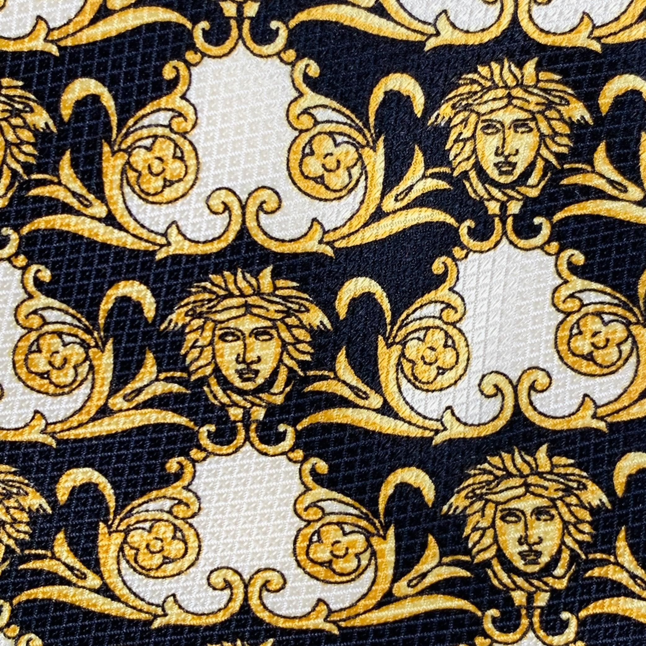 GIANNI VERSACE necktie
in a black and gold silk featuring signature Medusa heads pattern with Greca details. Made in Italy.Very Good Pre-Owned Condition. Signs of wear on back, unseen when worn. 

Measurements: 
  Width: 3.5 inches Length: 58 inches