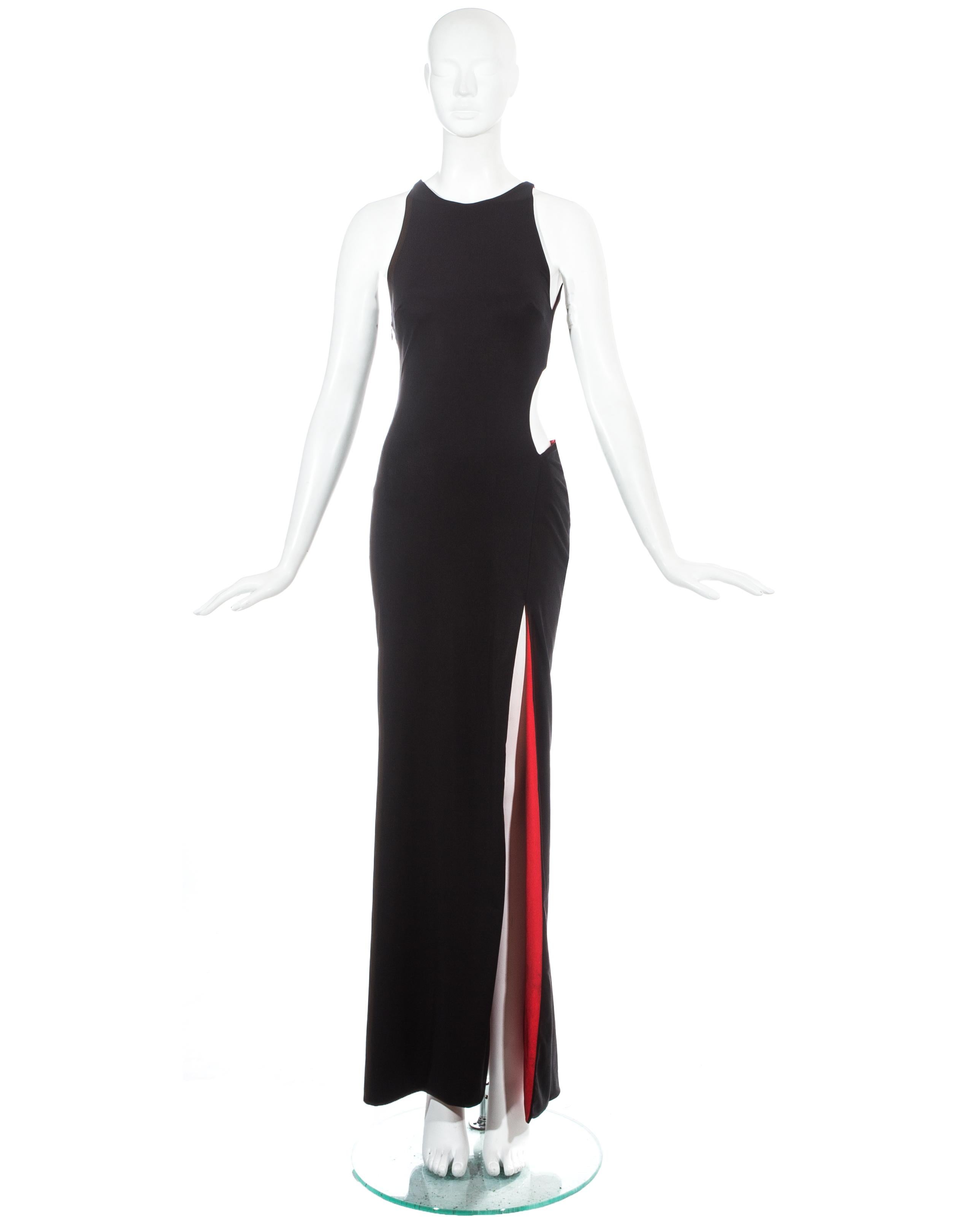 Gianni Versace; black jersey evening dress with high leg slit and large cut out on the waist. Red lining throughout.

Spring-Summer 1998