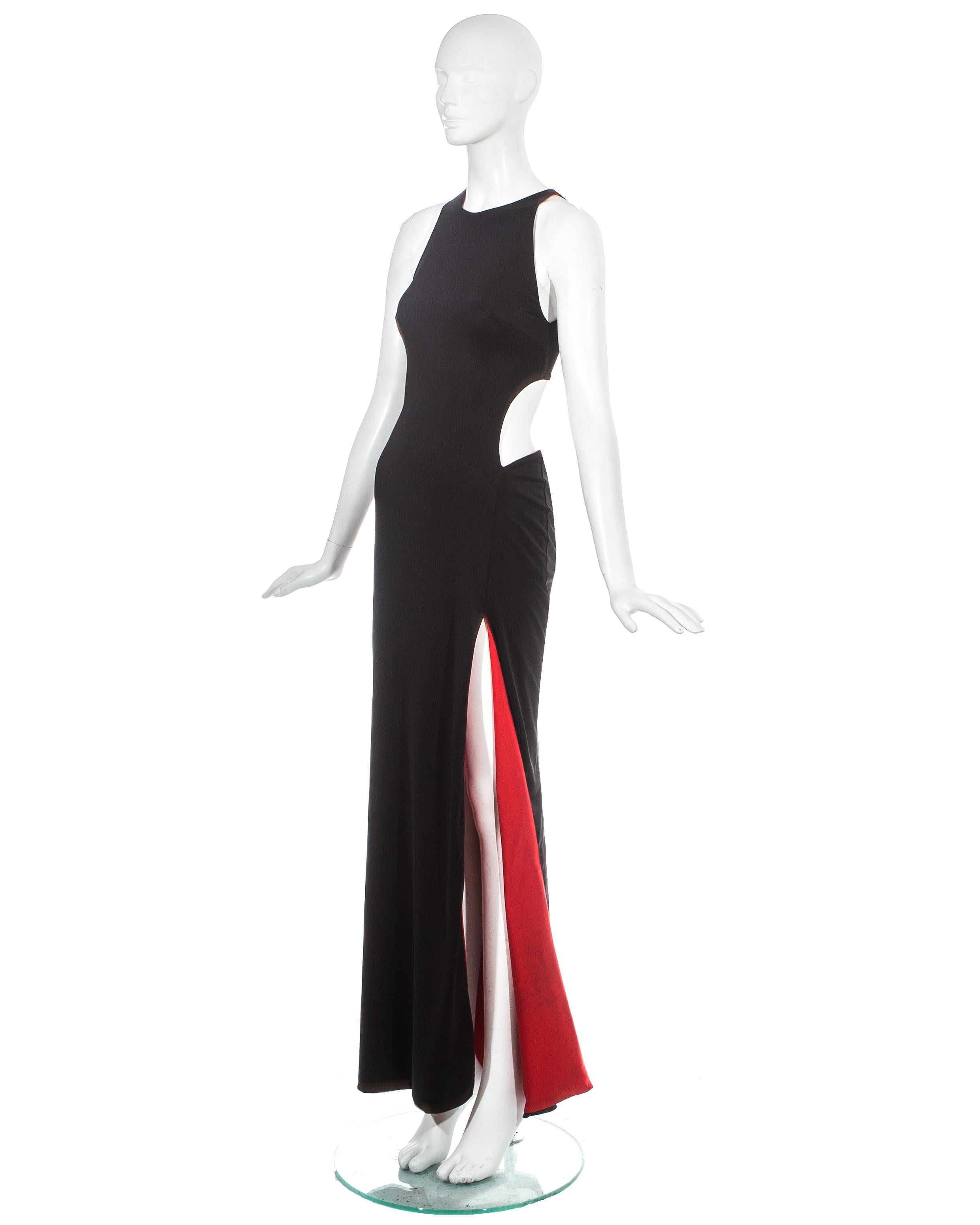 Gianni Versace; black jersey evening dress with high leg slit and large cut out on the waist. Red lining throughout.   

Spring-Summer 1998
