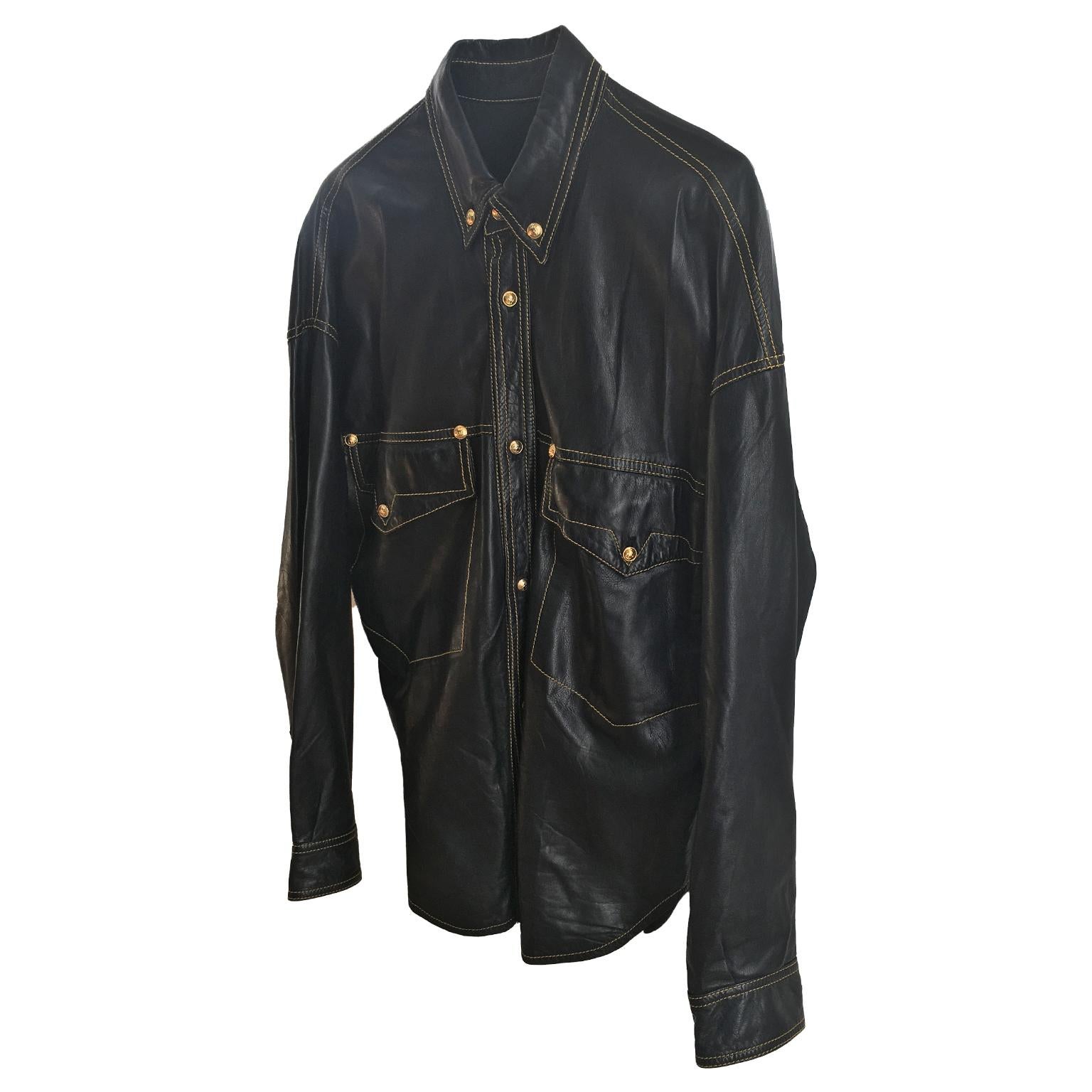 A legendary iconic shirt from the 1993 spring summer runway by Gianni Versace. 
Golden tone medusa head buttons, yellow cover stitch on black soft leather.
From neck point to cuff : 81 cm
Back length : 75 cm 

