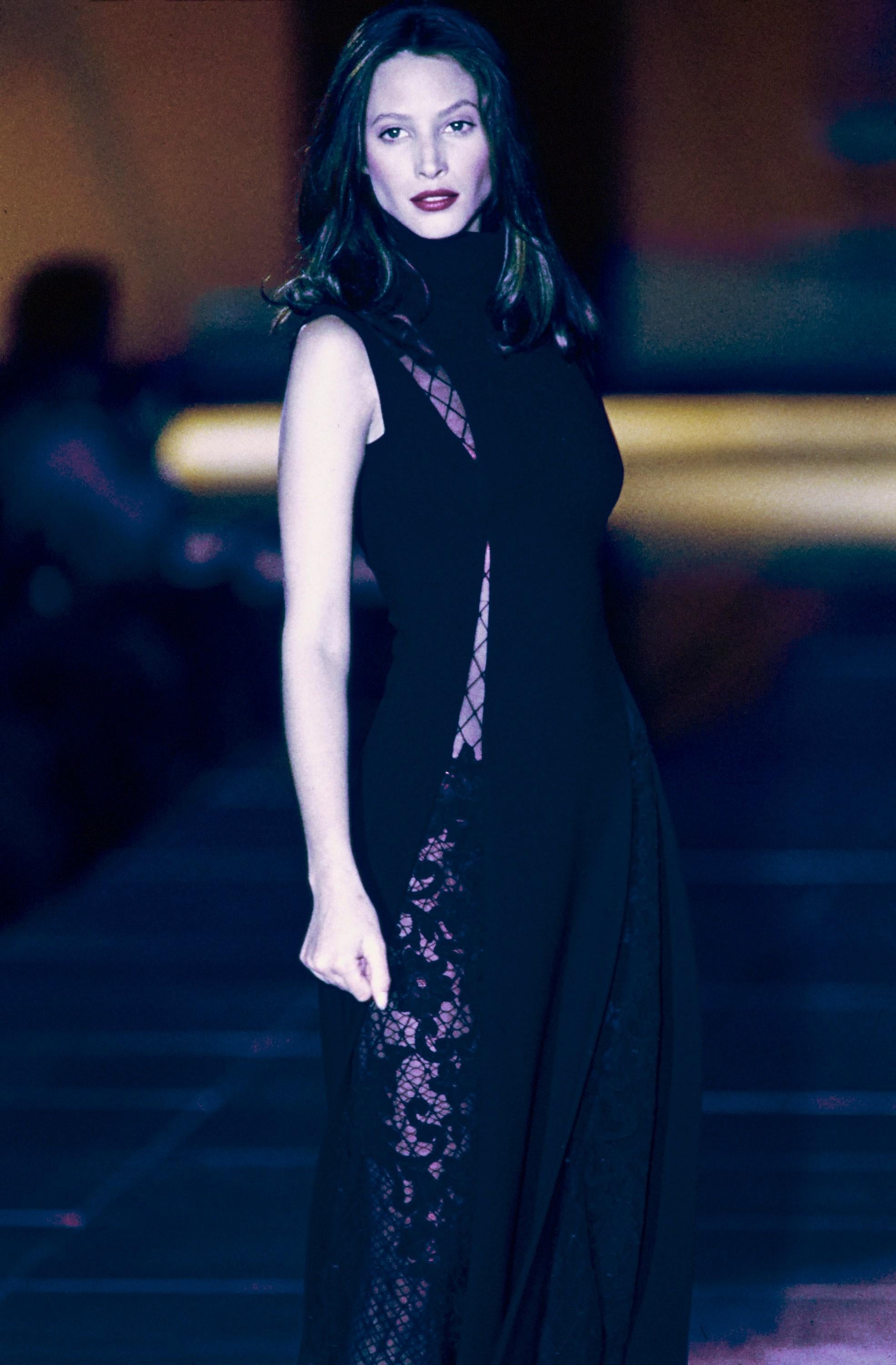 Gianni Versace black wool maxi dress with triangle lace cut outs and high leg slits

Fall-Winter 1993