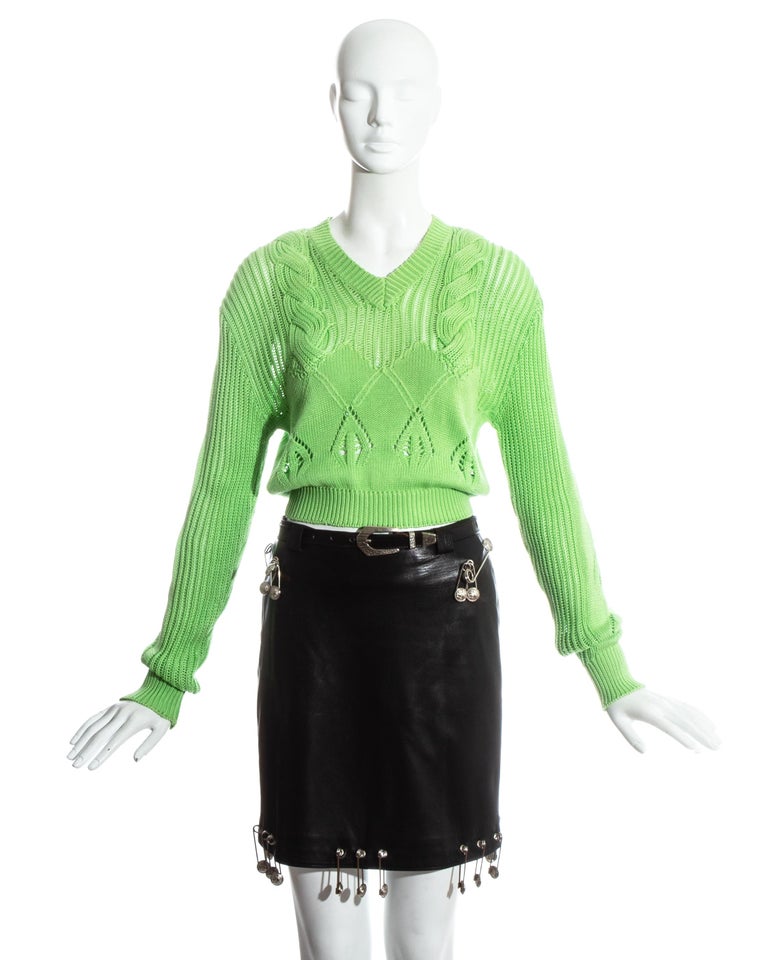 Gianni Versace black safety pin skirt and neon green sweater ensemble