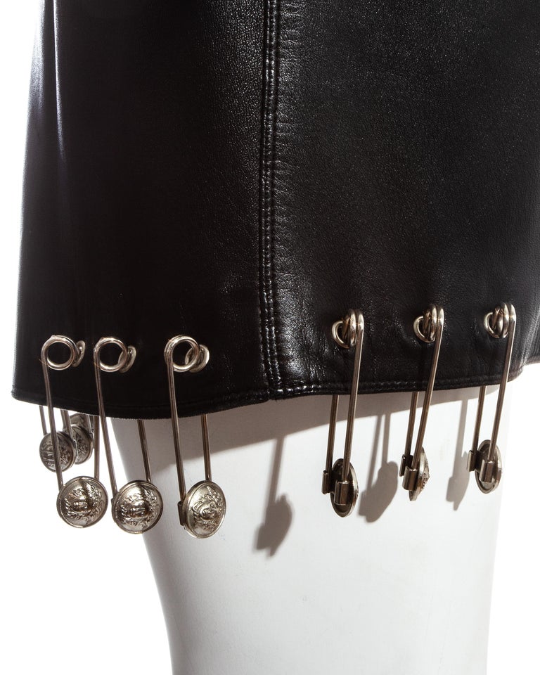 Gianni Versace black safety pin skirt and neon green sweater ensemble