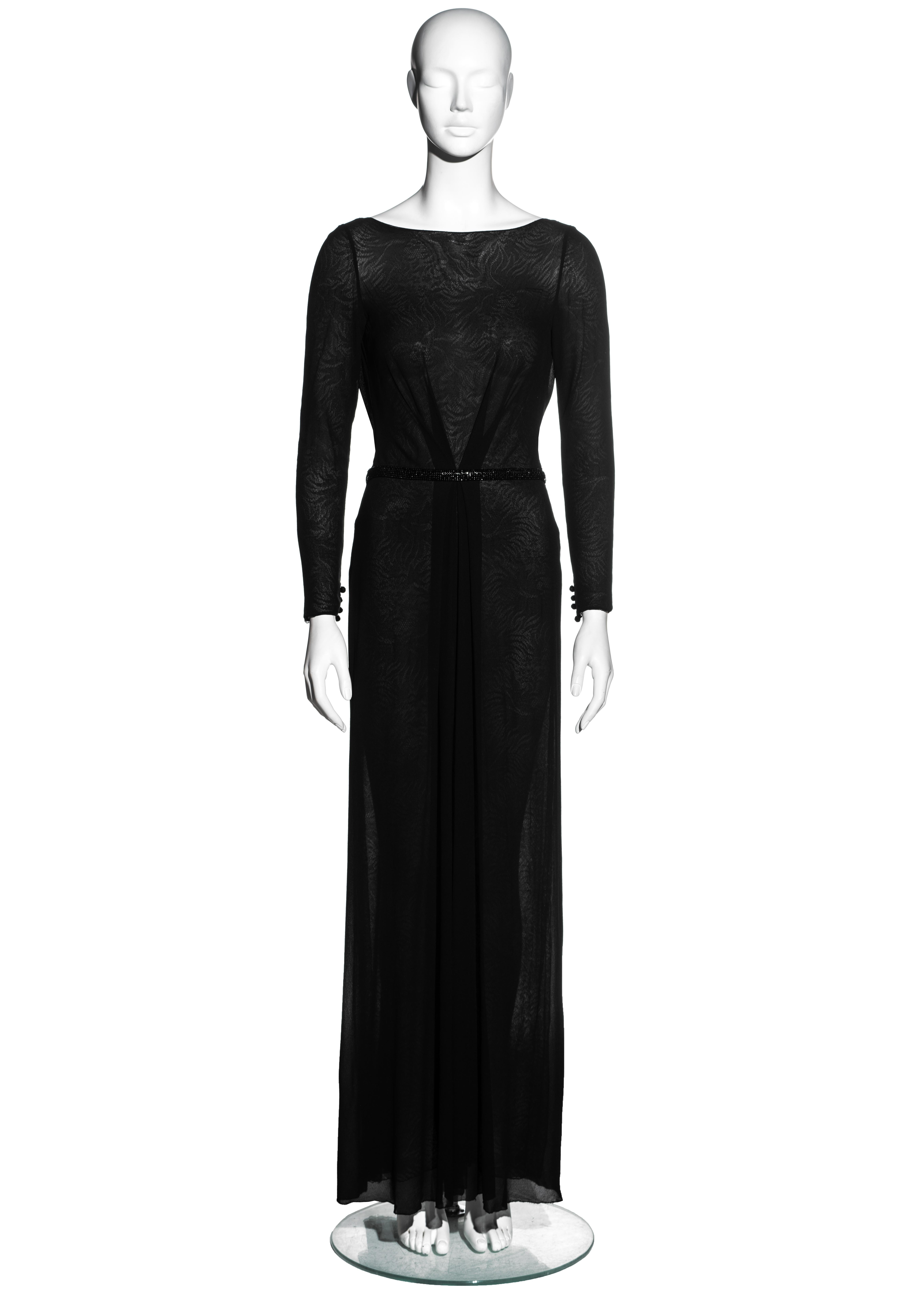 ▪ Gianni Versace black silk evening wrap dress
▪ Lace underlay 
▪ Open back 
▪ Beaded belt fastening 
▪ Boat neck
▪ Pleated detail at waist 
▪ Draped detail at back fastening 
▪ IT 38 - FR 34 - UK 6
▪ Fall-Winter 2000

