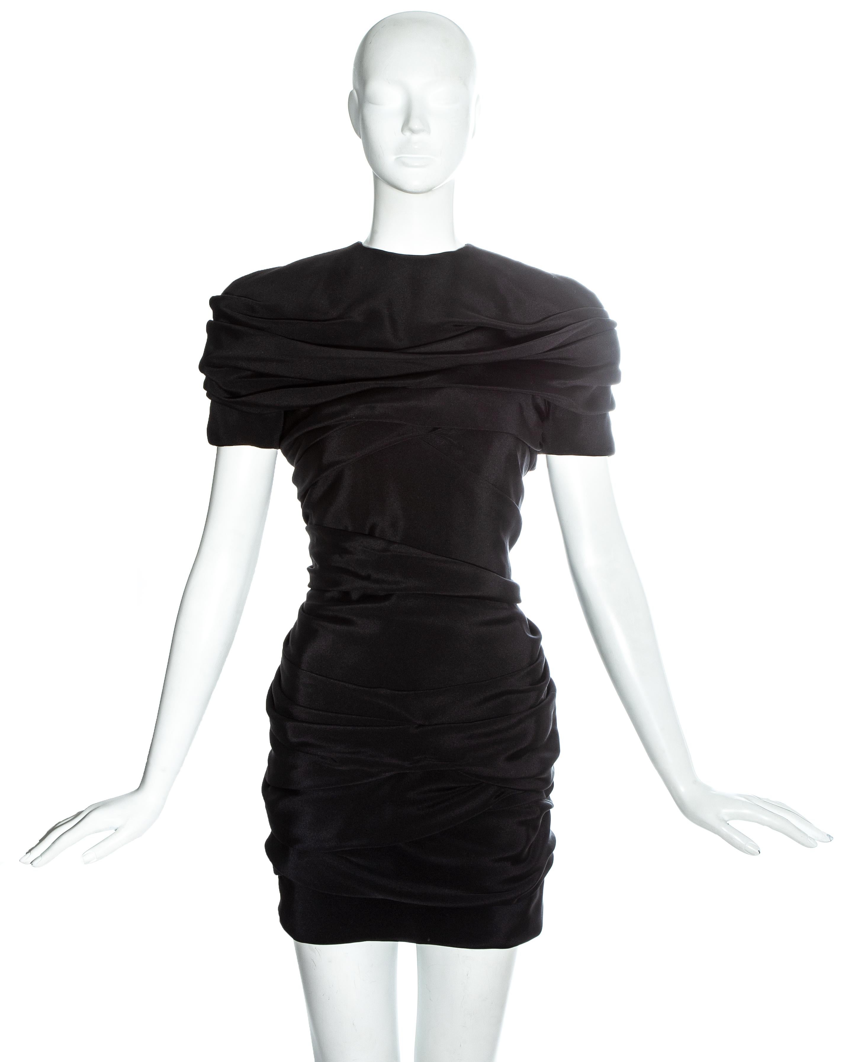 Gianni Versace black silk ruched mini dress with shoulder pads, accentuated waist and intricate pleating along spine

Spring-Summer 1987