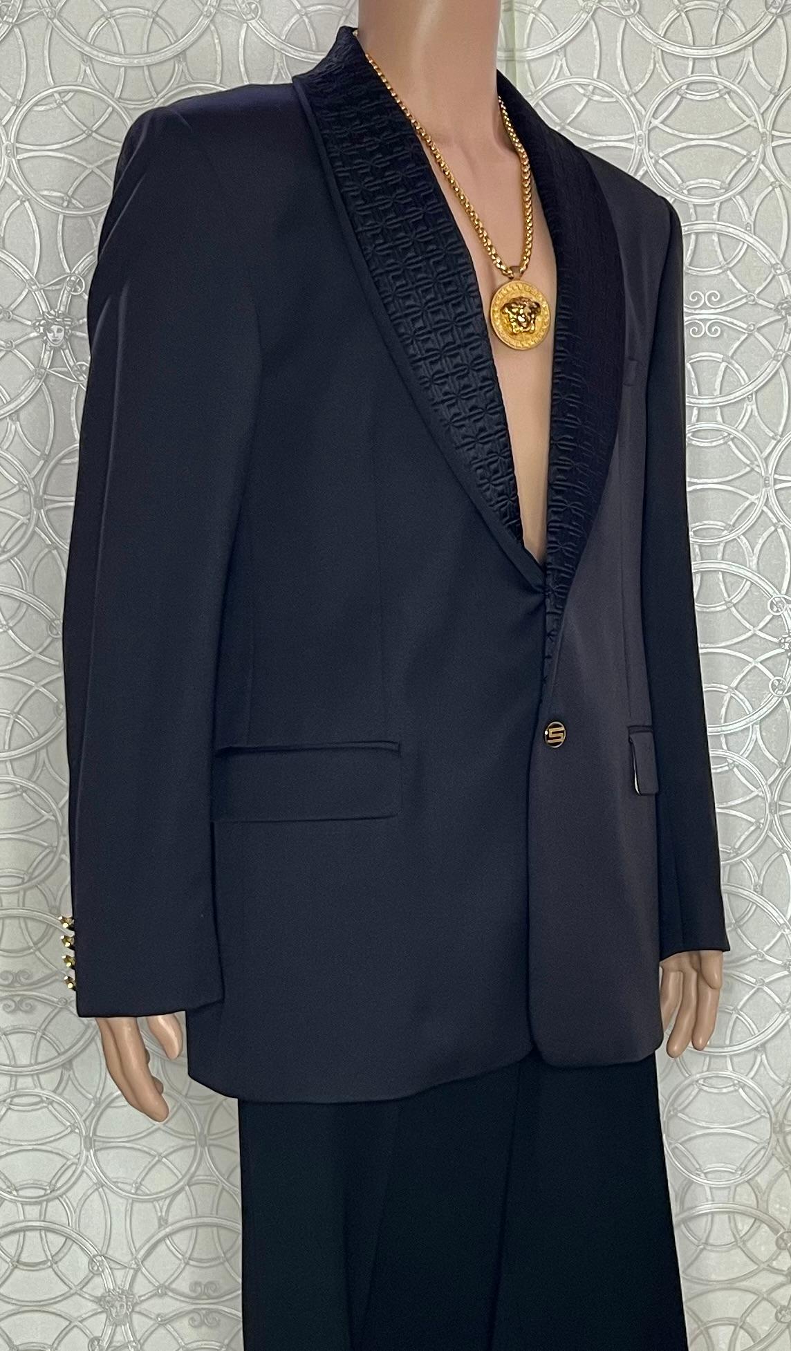 GIANNI VERSACE SUIT

Black wool suit 
Two button closure
Two pockets on jacket
Gold-tone Medusa buttons

Content: wool

IT Size 56 -  US 46 (3XL)

Measurements:
shoulder to shoulder: 20 1/2
