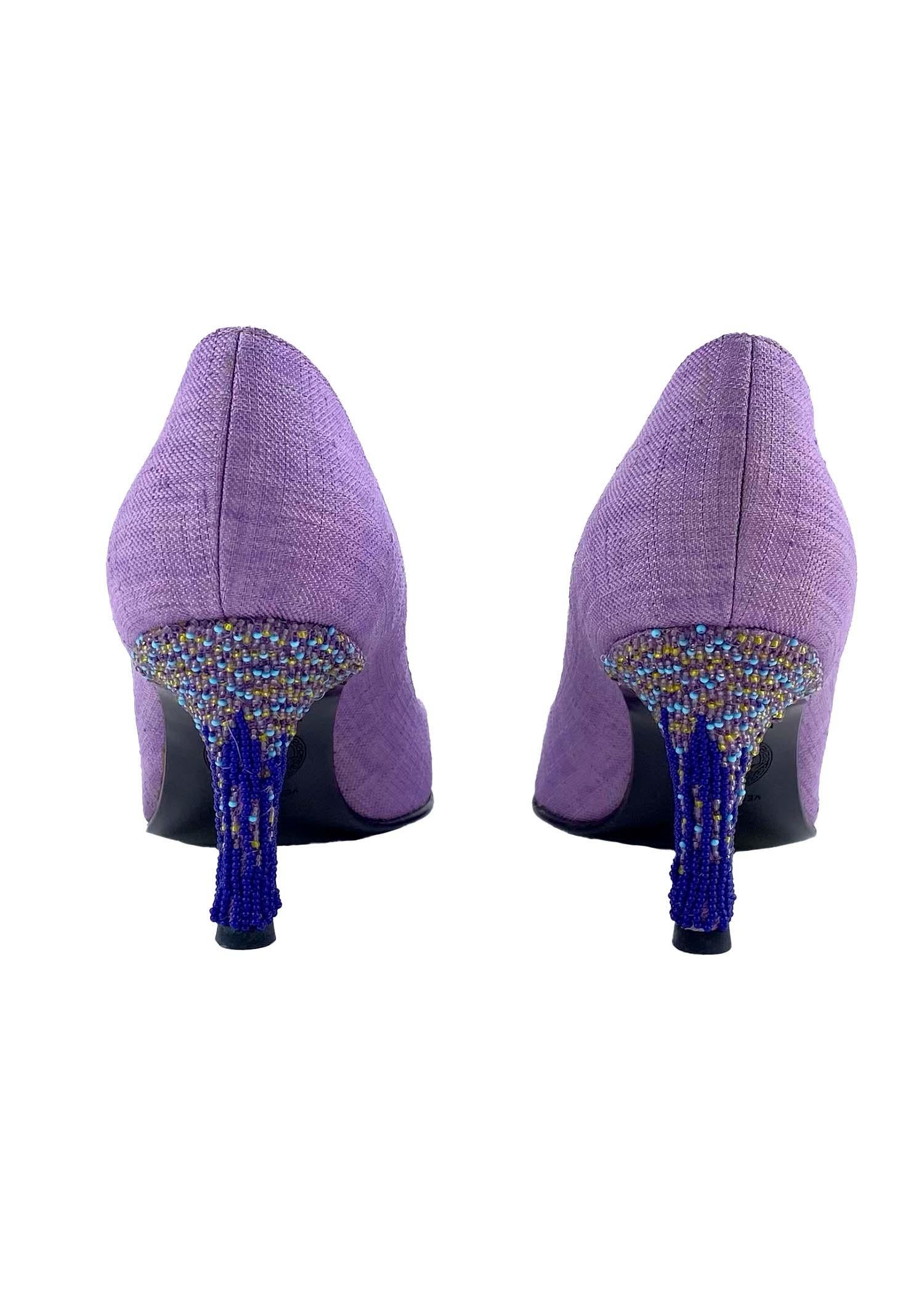 Presenting a beaded heel purple linen Versace pump, designed by Donatella Versace. This pair of heels is constructed primarily of lilac linen and features a heavily beaded heel. Simply magnificent, these shoes are masterfully built and