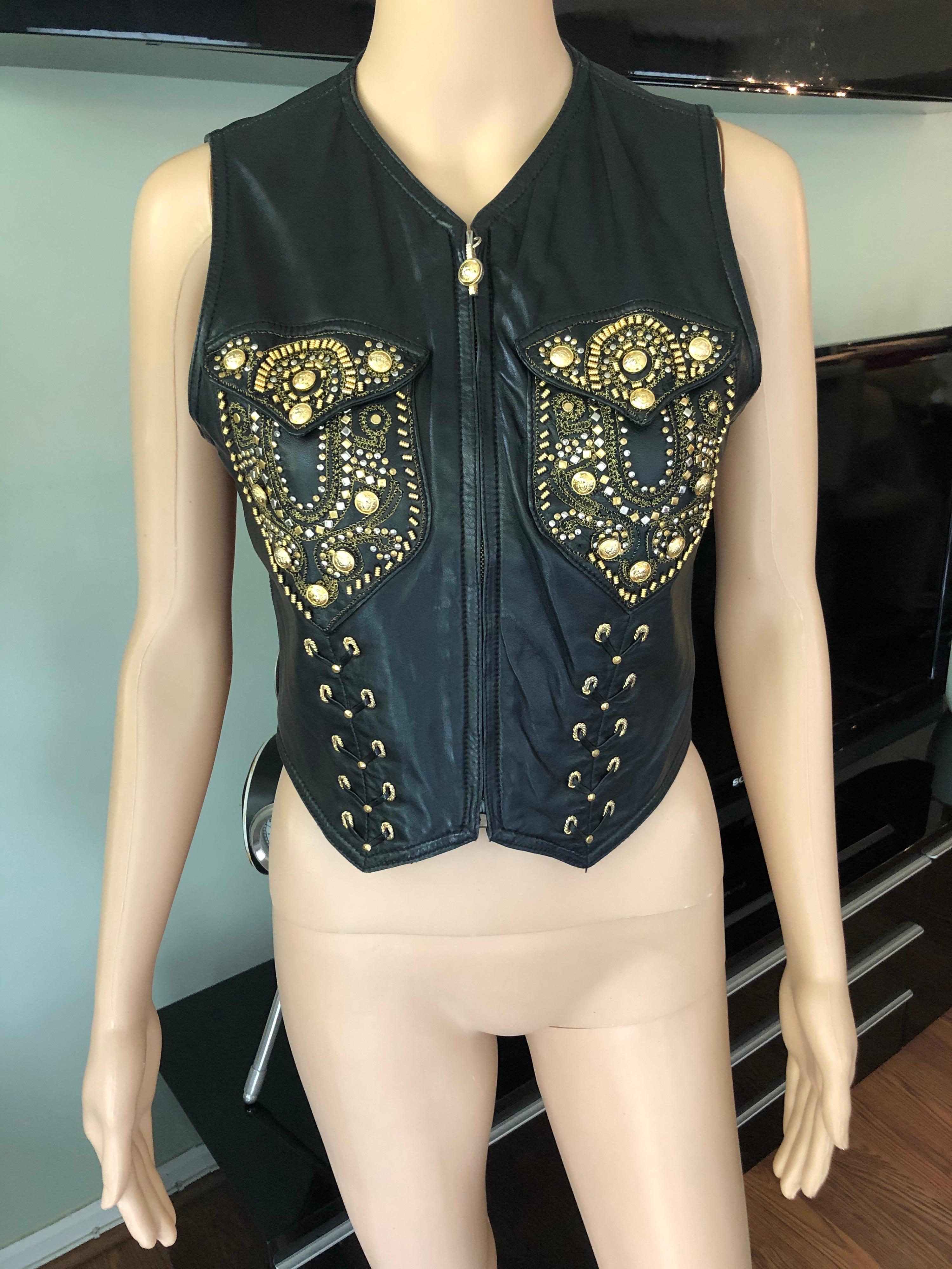 Gianni Versace black leather vest featuring gold studded embellishments throughout,  lace up detail, dual chest flap pockets and zip closure at front. Please note the size tag has been removed. Please find below the approximate measurements:
Chest: