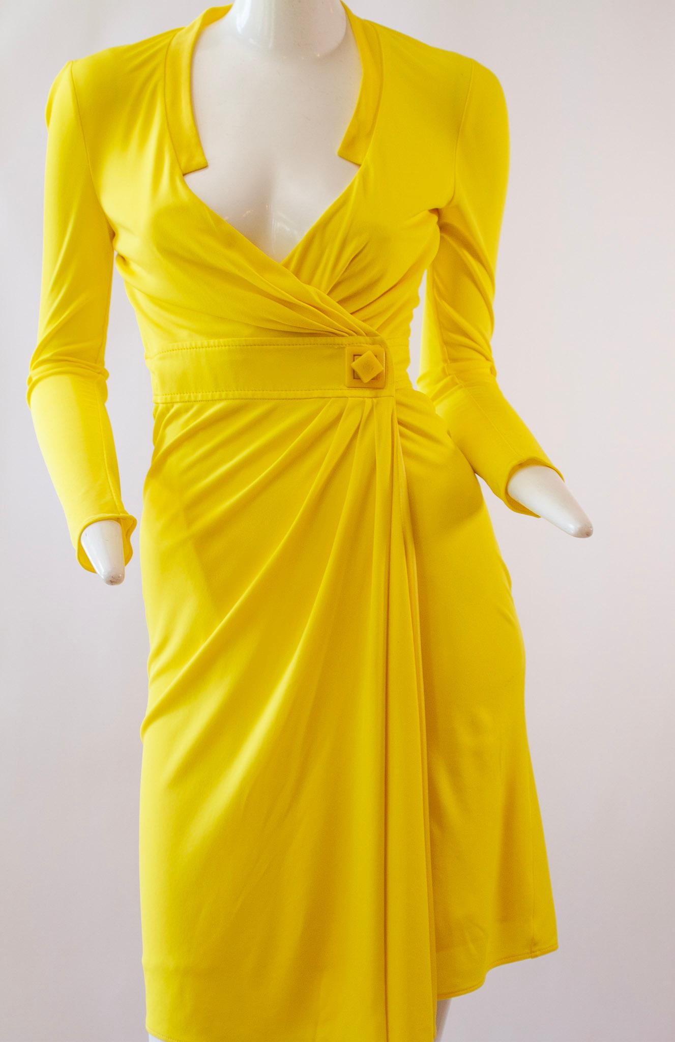 GIANNI VERSACE, Canary Yellow Mid-Length Wrap Dress with Rotating Square Medusa Fastener. Long Sleeves and Plunging Neckline
Early 2000s

size 38

Medusa head square button fastener detail.