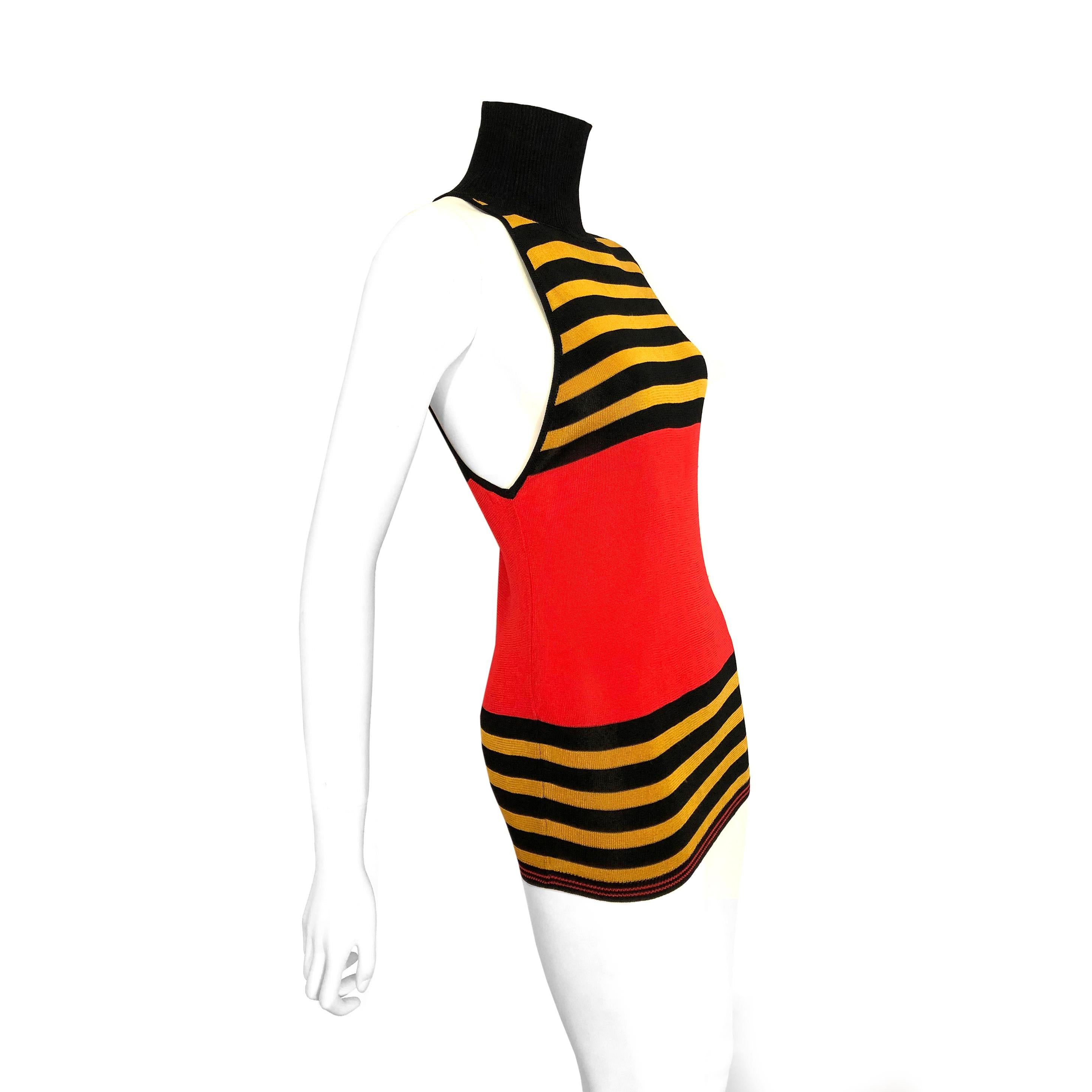 Product Details: Gianni Versace Couture - 1980s Vintage Top / Lightweight Knitted Top / Mustard-Gold, Orange-Red + Black Stripes - Asymmetric Sleeve Detailing - Ribbed Polo Neck Worn - Two Ways.
Label: Gianni Versace Couture
Era: 1980s Vintage
Size:
